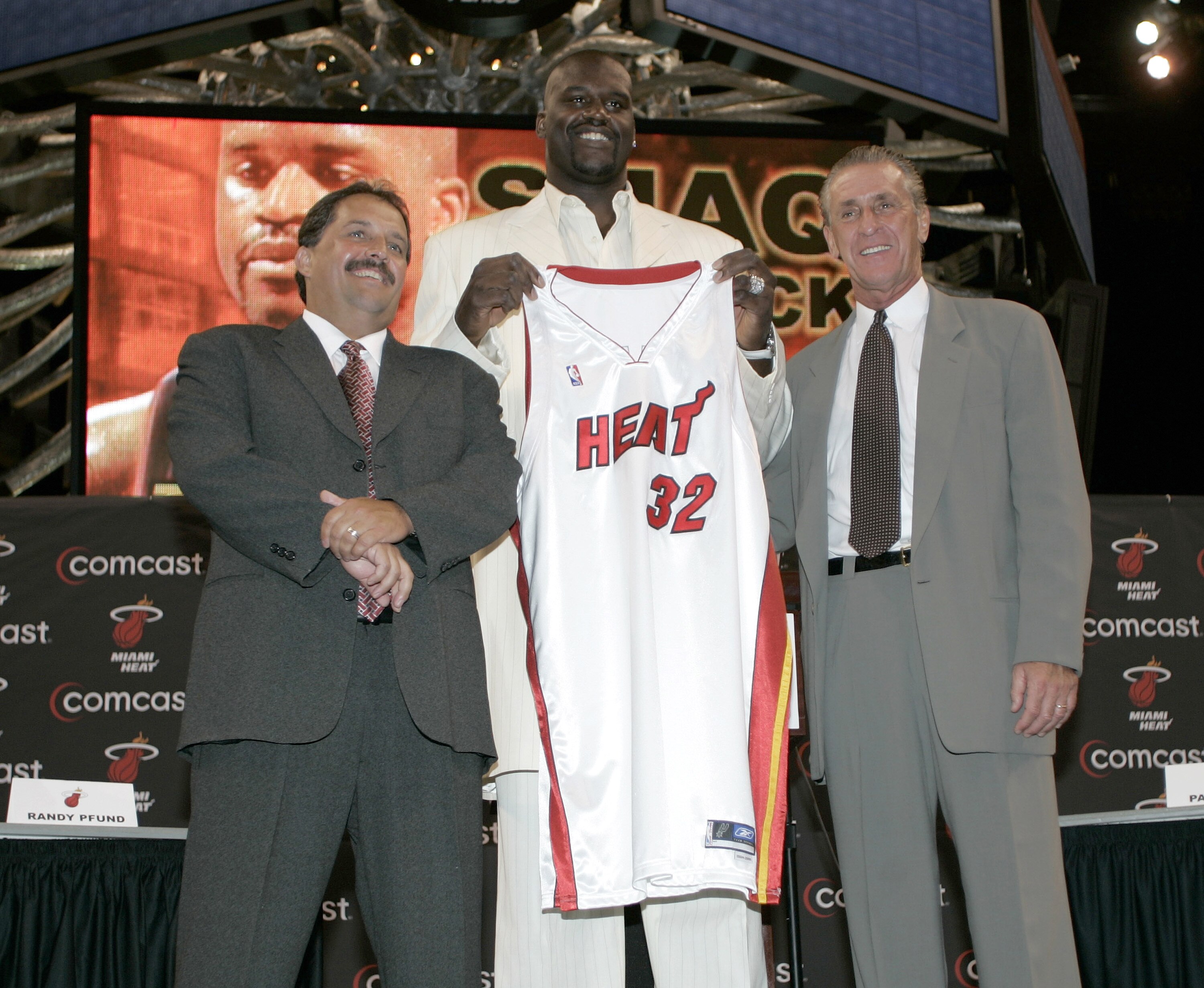 MIAMI - JULY 20:  Shaquille O'Neal of the Miami Heat holds up his new #32 jersey with Coach Stan Van Gundy (L) and Pat Riley (R) at his sides during a press conference to offically announce his arrival to the Miami Heat July 20, 2004 at the American Airli