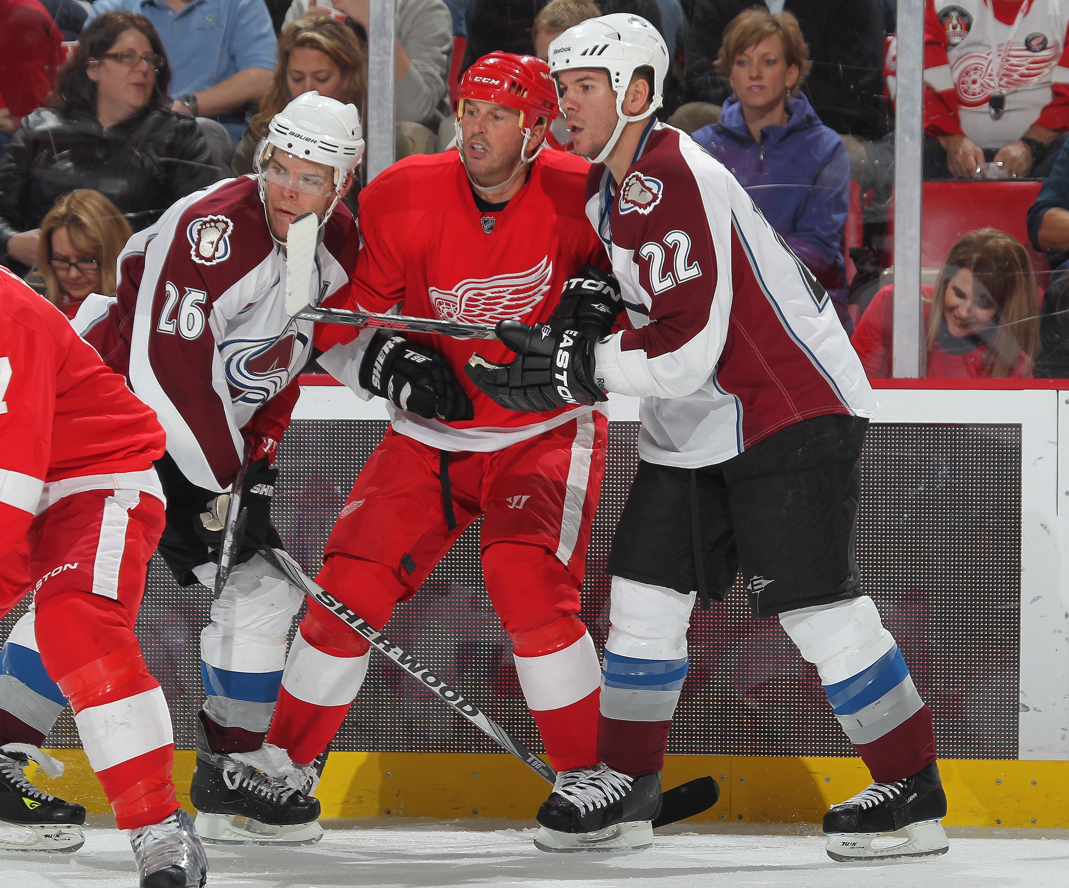 DETROIT,MI - NOVEMBER 13:  Mike Modano #90 of the Detroit Red Wings is sandwiched by Paul Stastny #26 and Scott Hannan #22 of the Colorado Avalanche in a game on November 13,2010 at the Joe Louis Arena in Detroit, Michigan. The Wings defeated the Avalanch