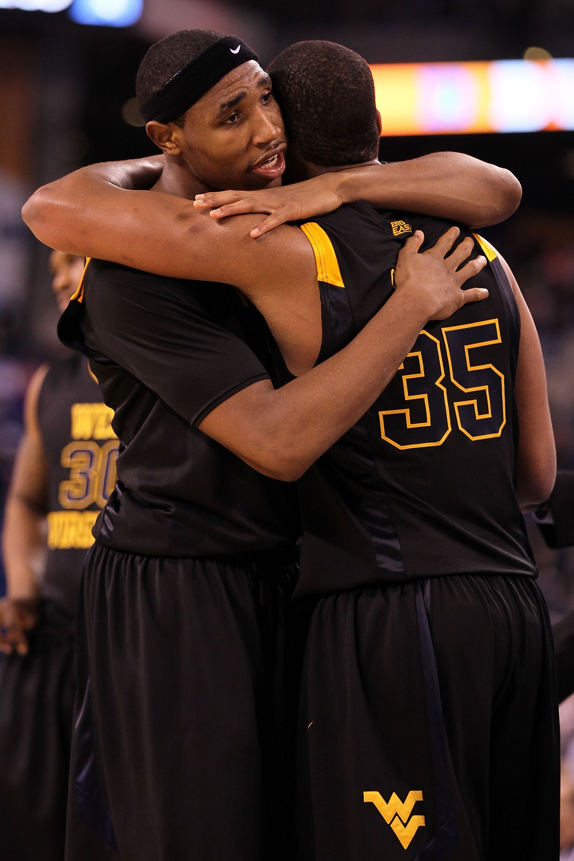 INDIANAPOLIS - APRIL 03:  Kevin Jones #5 and Wellington Smith #35 of the West Virginia Mountaineers hug after losing to the Duke Blue Devils during the National Semifinal game of the 2010 NCAA Division I Men's Basketball Championship at Lucas Oil Stadium