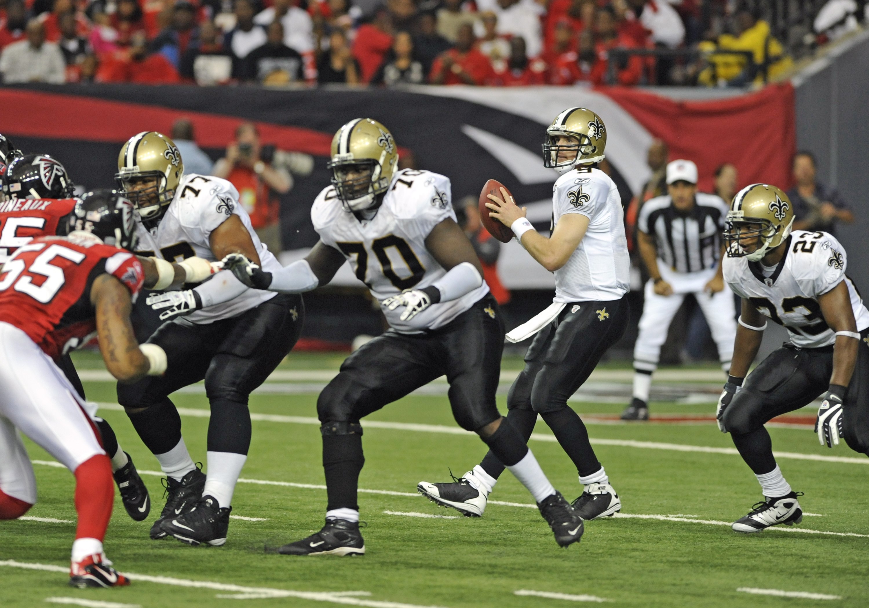 ATLANTA - NOVEMBER 9: Quarterback Drew Brees #9 of the New Orleans Saints sets to pass behind the block of tackle Jammal Brown #70 against the Atlanta Falcons at the Georgia Dome on November 9, 2008 in Atlanta, Georgia.  (Photo by Al Messerschmidt/Getty I