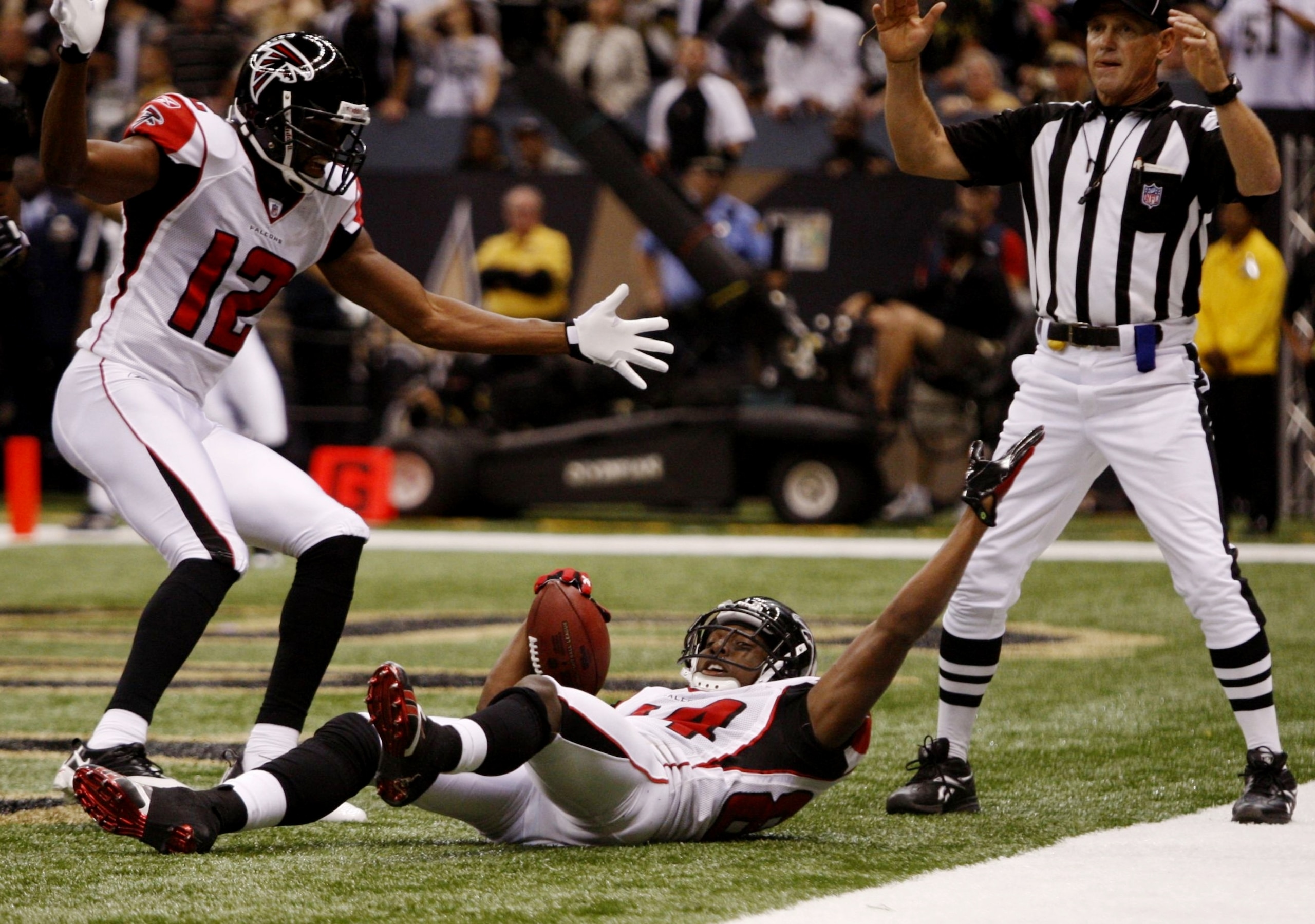NEW ORLEANS - NOVEMBER 2:  Roddy White #84 of the Atlanta Falcons celebrates his touchdown with teammate Michael Jenkins #12 against the New Orleans Saints during the third quarter of the game at the Louisiana Superdome on November 2, 2009 in New Orleans,