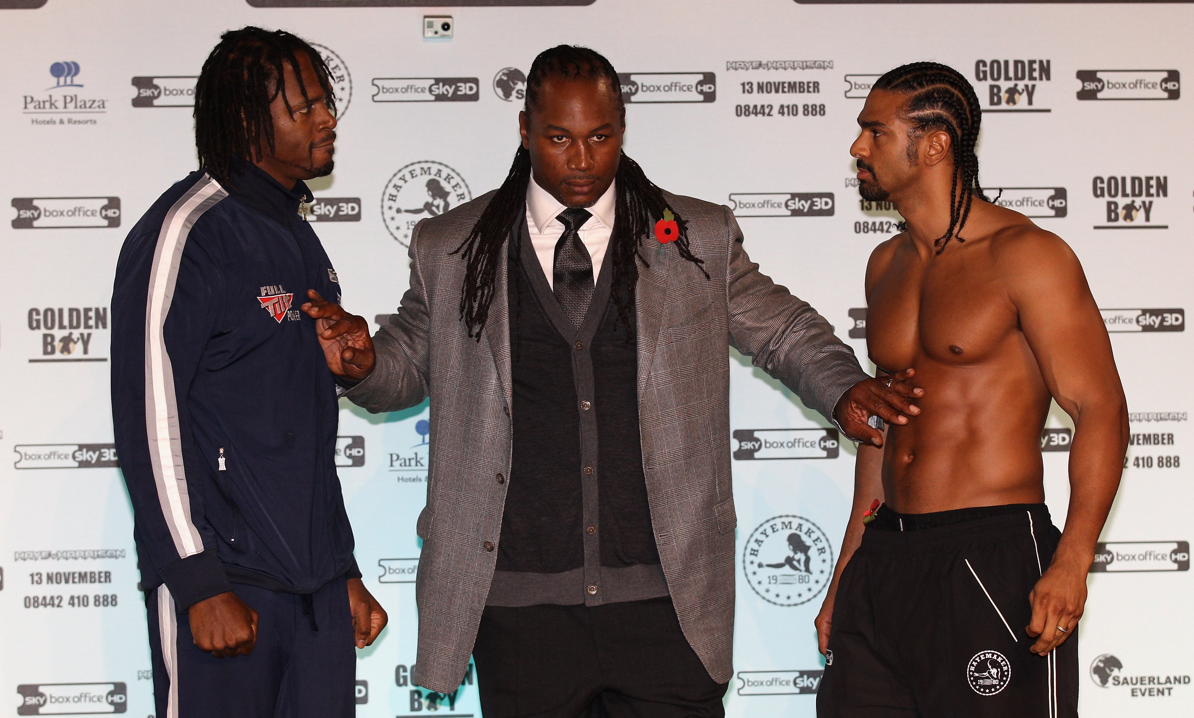 MANCHESTER, ENGLAND - NOVEMBER 12:  Former heavyweight champion of the world, Lennox Lewis, steps in between David Haye and Audley Harrison as they go face to face during the official weigh-in at The Lowry Theatre on November 12, 2010 in Manchester, Engla