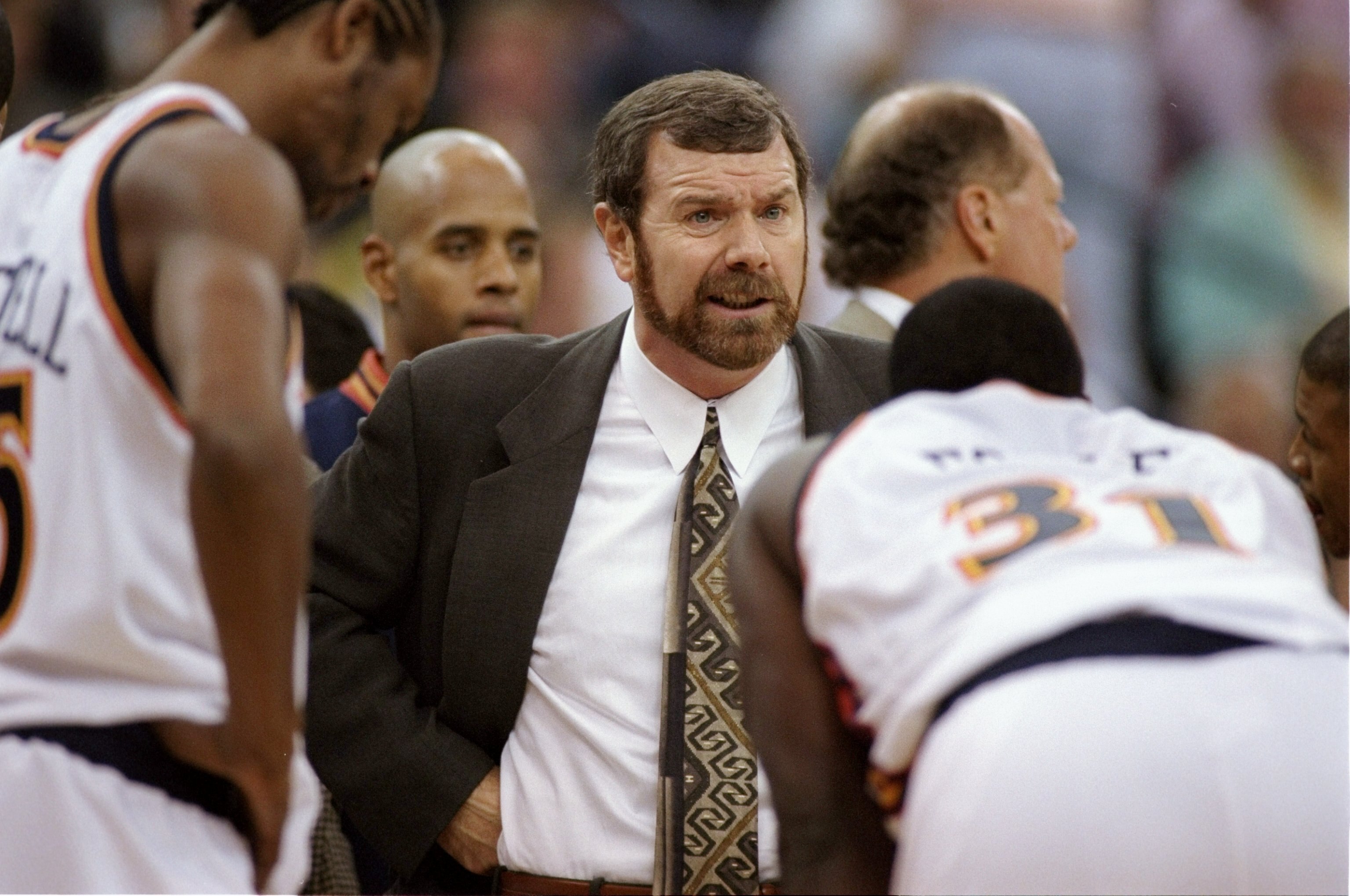 12 Nov 1997:  Head coach P.J. Carlesimo of the Golden State Warriors (middle) talks with Adonal Foyle #31 and Latrell Sprewell (L) during the Warriors 102-71 loss to the Detroit Pistons at the Oakland Coliseum in Oakland, California.  Mandatory Credit: Ot