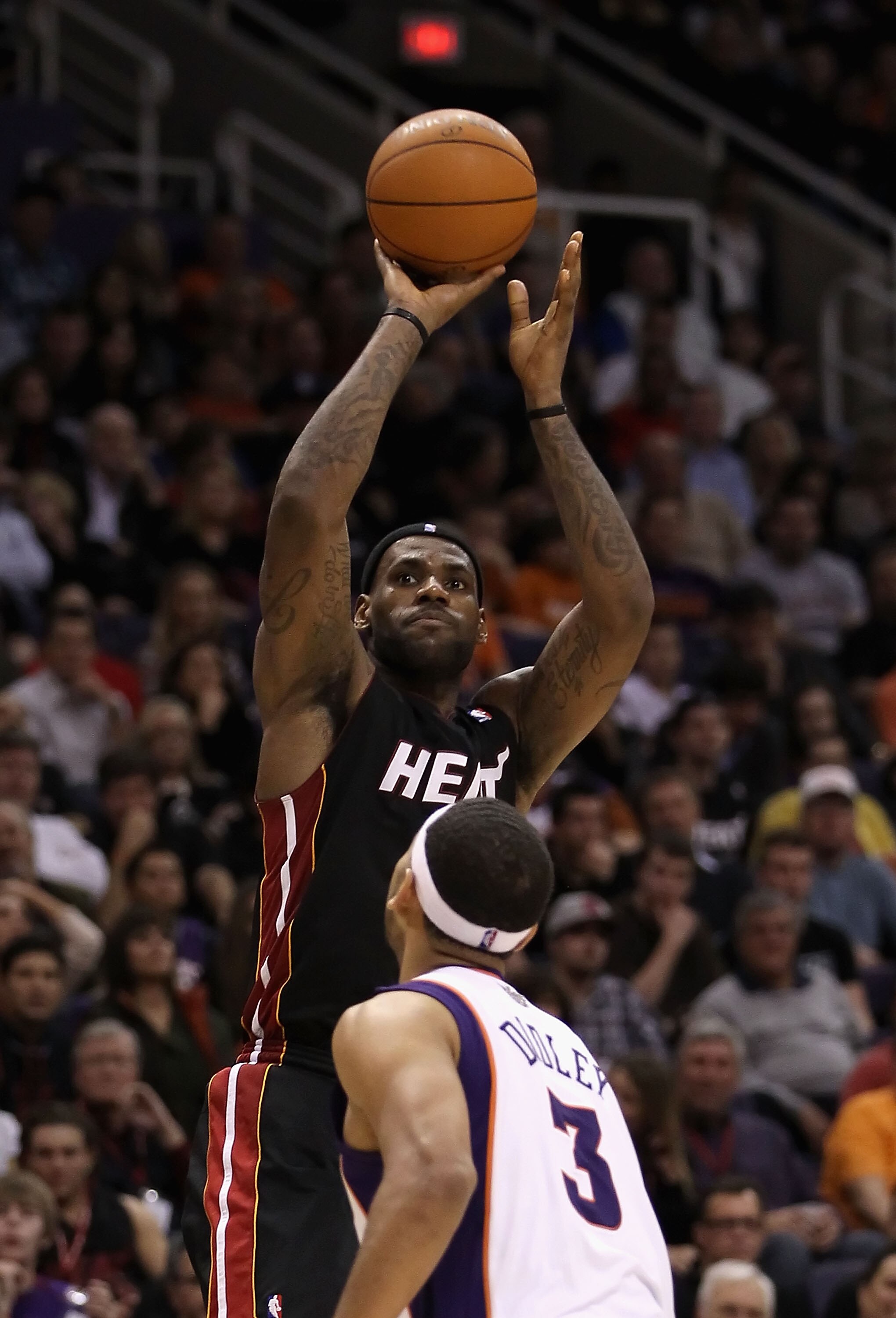 PHOENIX - DECEMBER 23:  LeBron James #6 of the Miami Heat puts up a shot over Jared Dudley #3 of the Phoenix Suns during the NBA game at US Airways Center on December 23, 2010 in Phoenix, Arizona. The Heat defeated the Suns 95-83.  NOTE TO USER: User expr