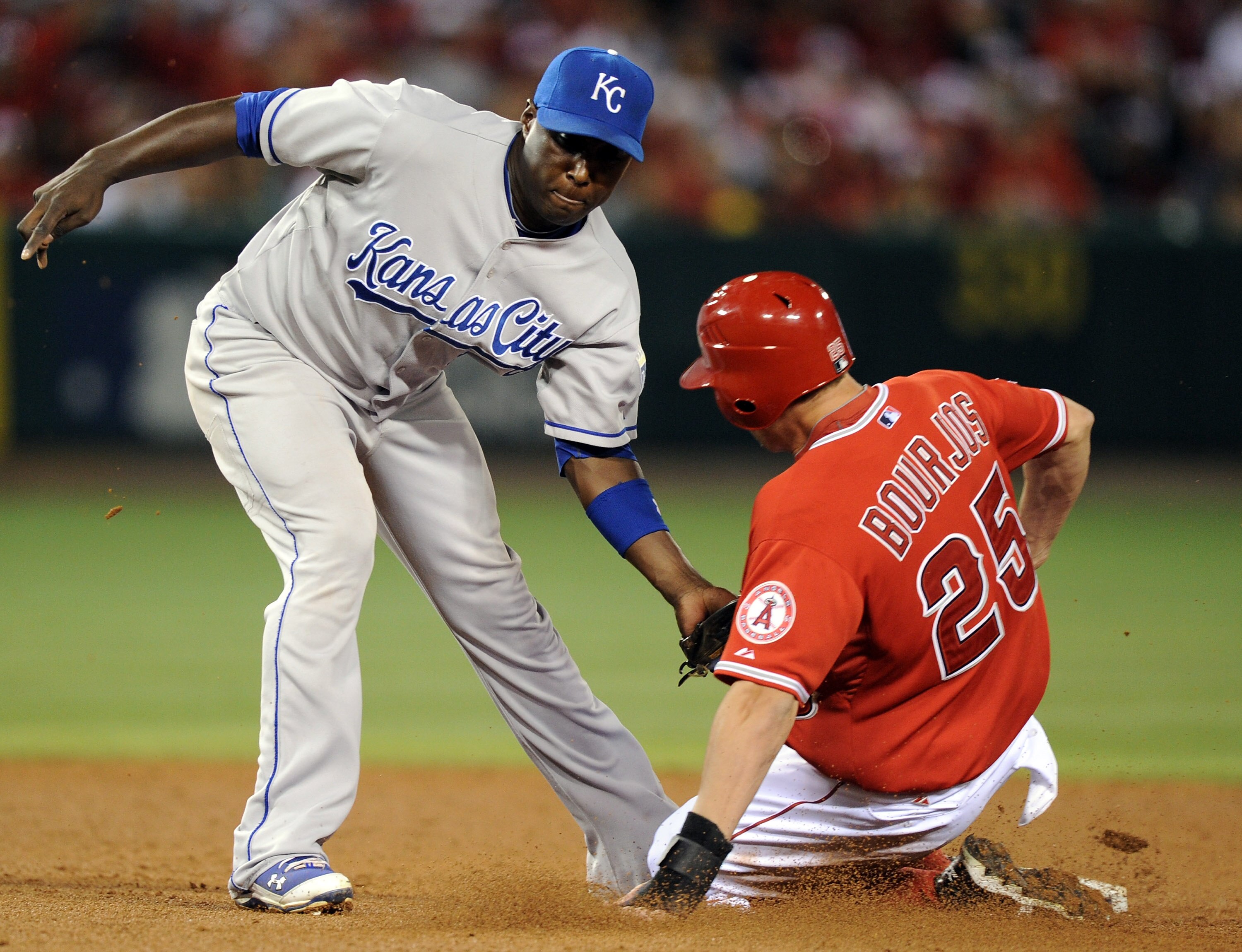 ANAHEIM, CA - AUGUST 10:  Yuniesky Betancourt #3 of the Kansas City Royals puts a tag on Peter Bourjos #25 of the Los Angeles for an out during the fifth inning at Angel Stadium on August 10, 2010 in Anaheim, California.  (Photo by Harry How/Getty Images)