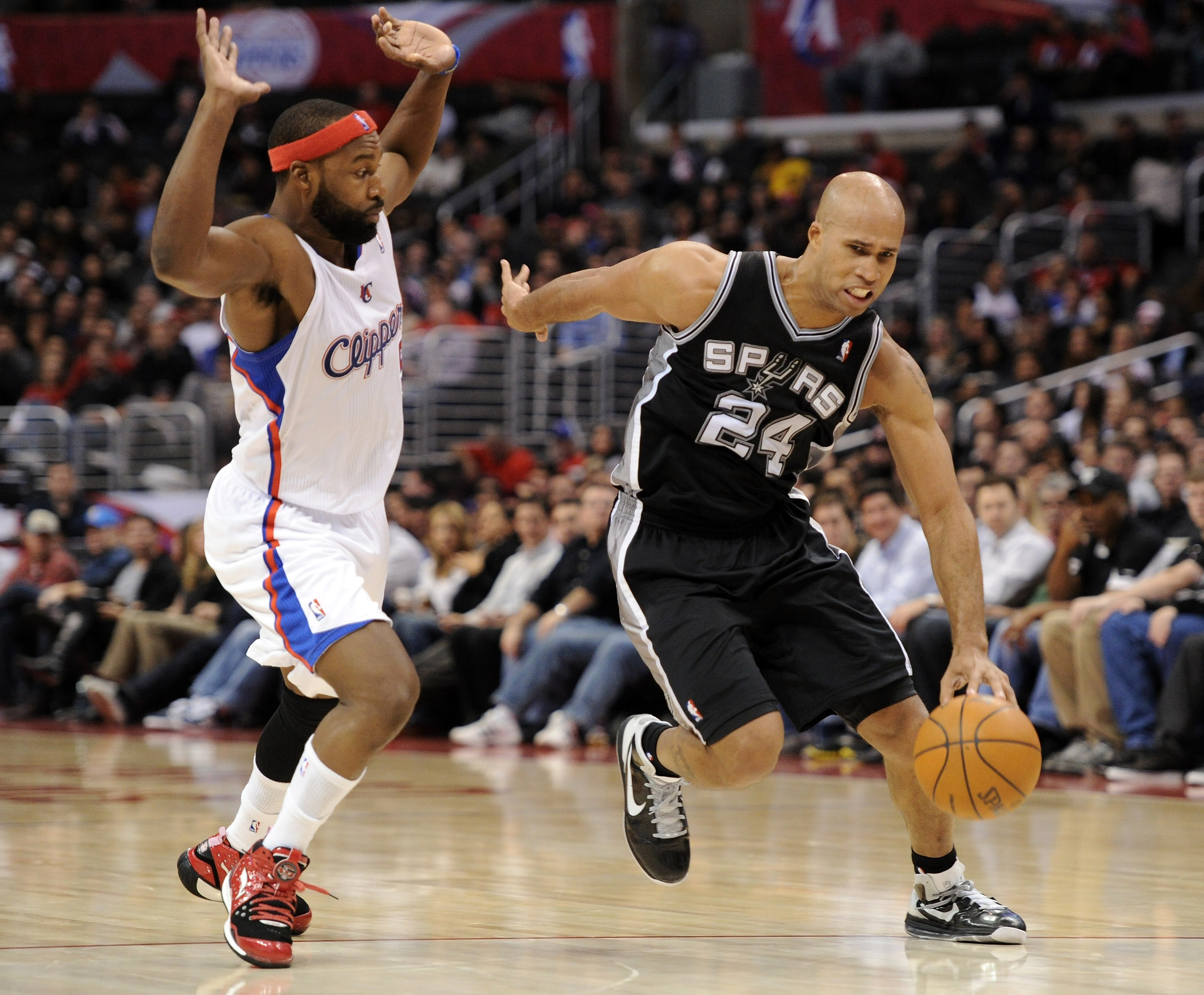 LOS ANGELES, CA - DECEMBER 01:  Richard Jefferson #24 of the San Antonio Spurs dribbles around Baron Davis #5 of the Los Angeles Clippers at the Staples Center on December 1, 2010 in Los Angeles, California.  NOTE TO USER: User expressly acknowledges and