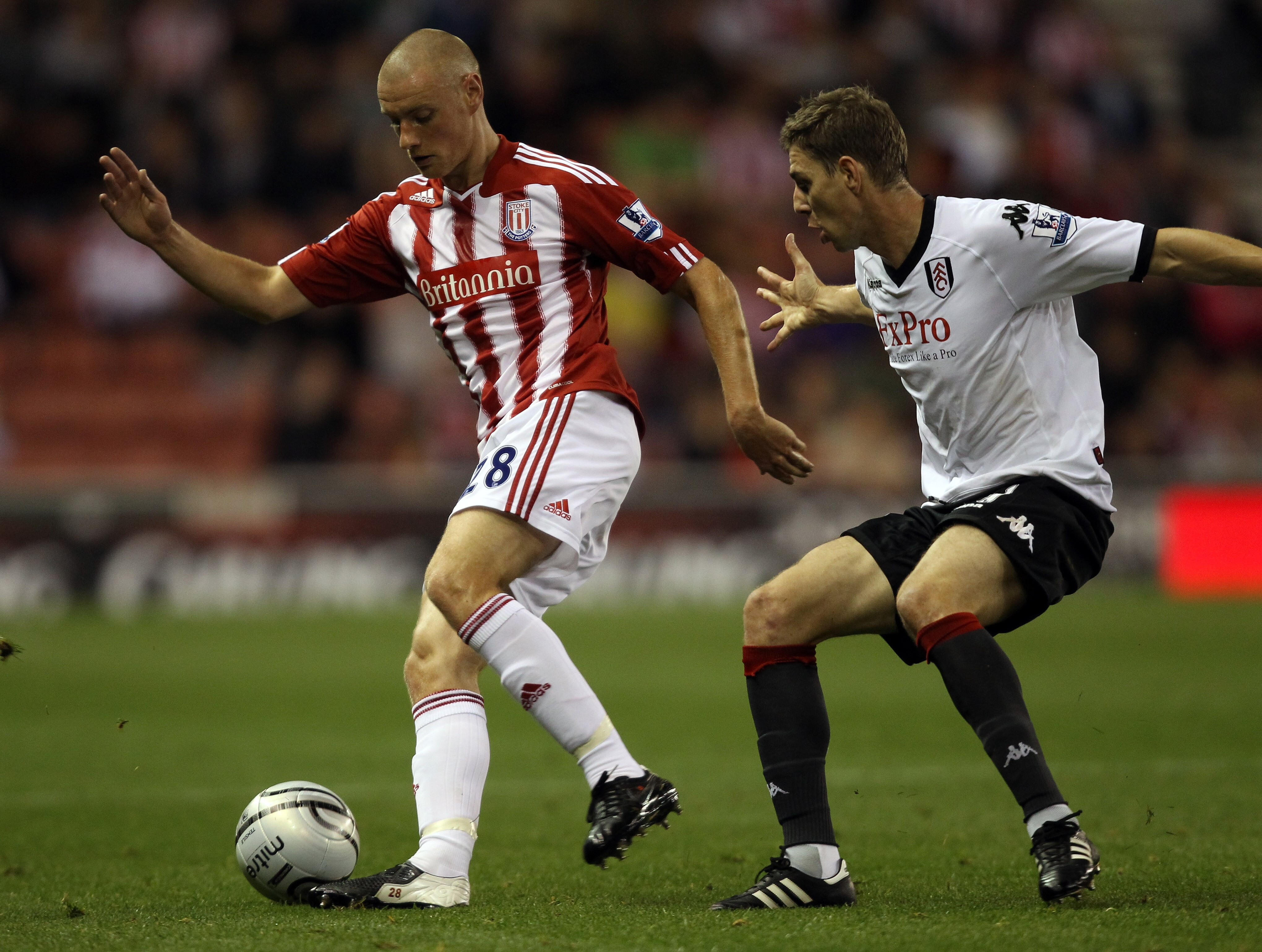 STOKE ON TRENT, ENGLAND - SEPTEMBER 21:  Andy Wilkinson of Stoke is challenged by Zoltan Gera of Fulham during the Carling Cup 3rd Round tie between Stoke City and Fulham at the Britannia Stadium on September 21, 2010 in Stoke on Trent, England.  (Photo b
