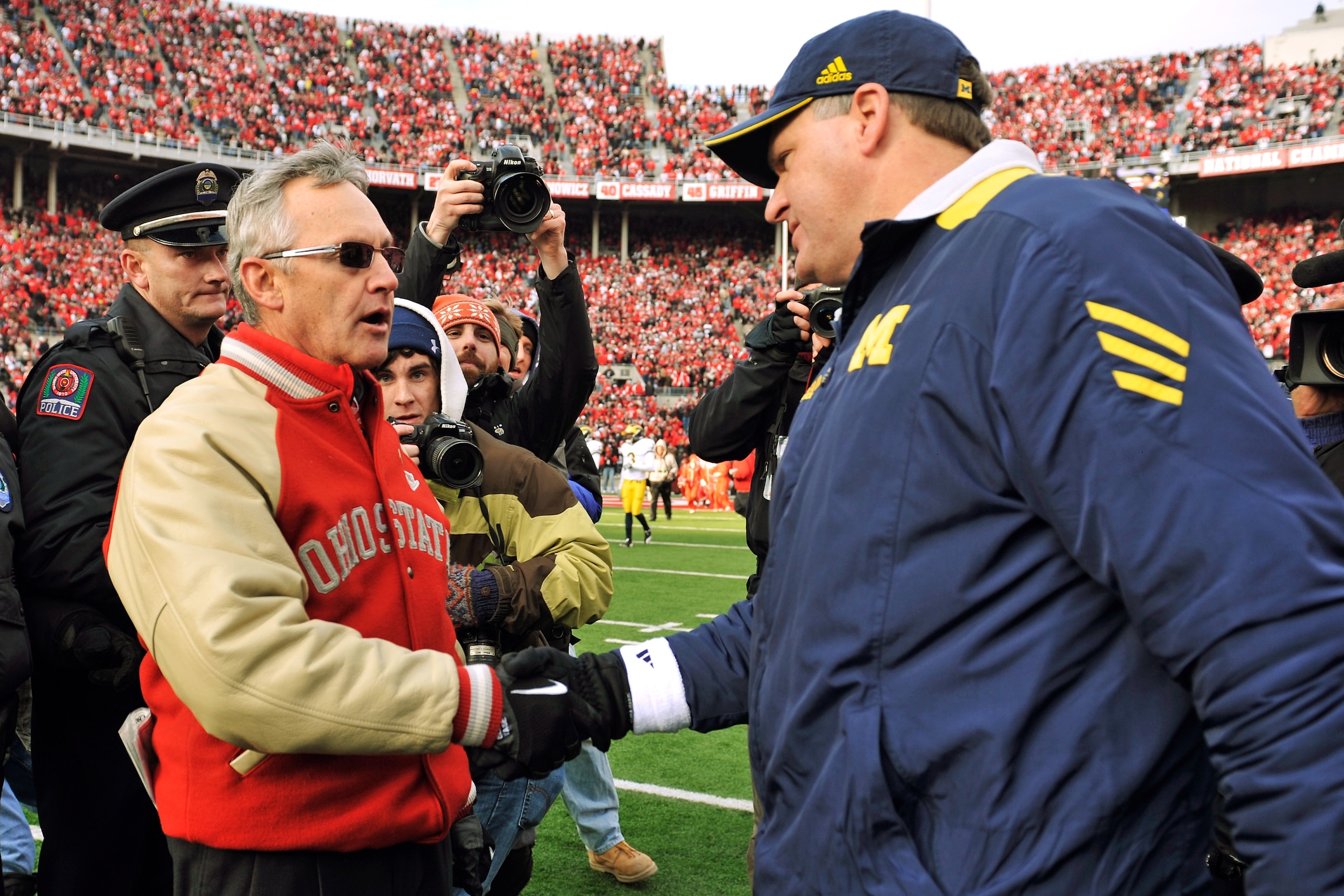 COLUMBUS, OH - NOVEMBER 27:  Head Coach Jim Tressel of the Ohio State Buckeyes shakes hands with Head Coach Rich Rodriguez after the Buckeyes defeated the Wolverines 37-7 at Ohio Stadium on November 27, 2010 in Columbus, Ohio.  (Photo by Jamie Sabau/Getty