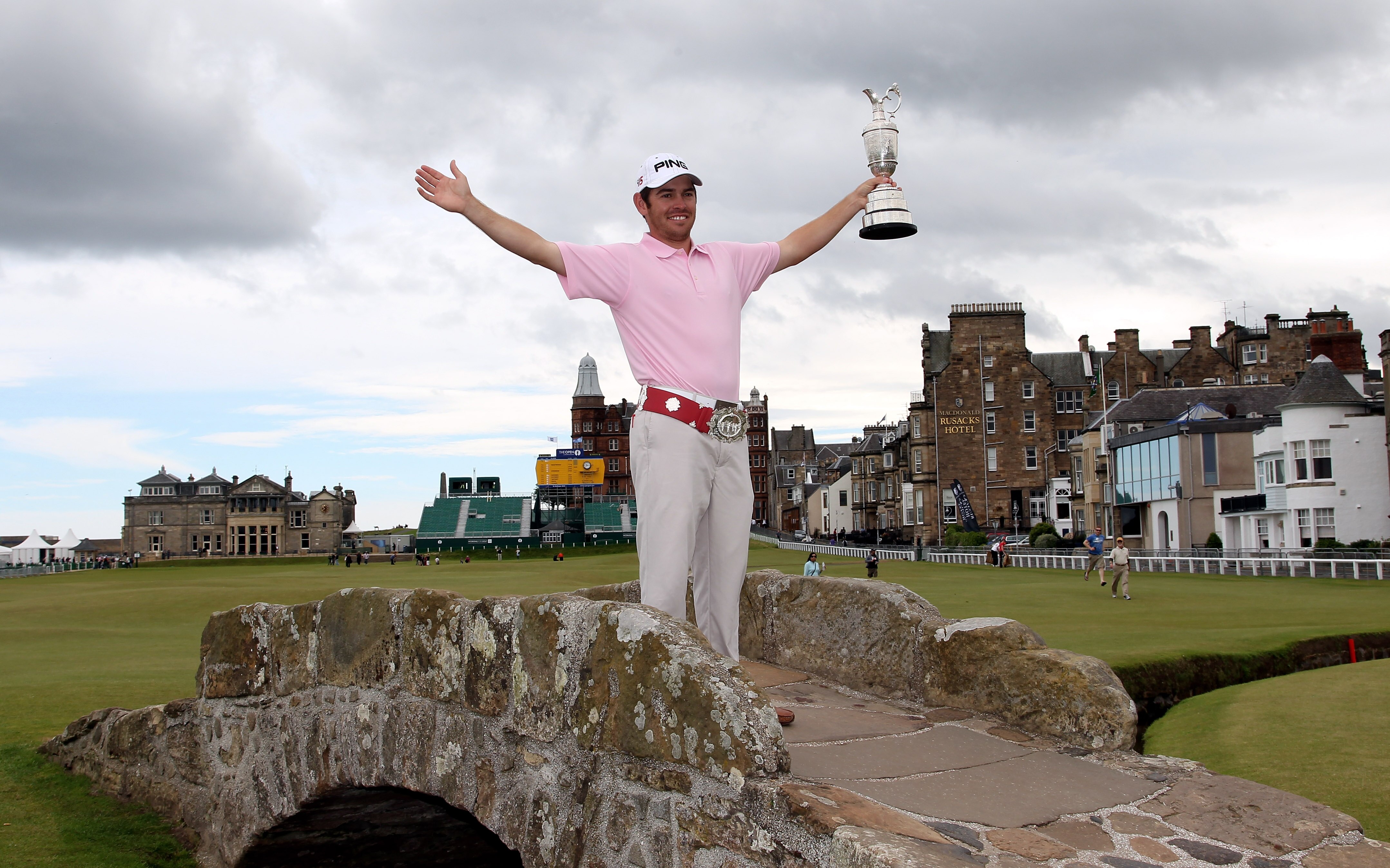 ST ANDREWS, SCOTLAND - JULY 19:  Open Champion Louis Oosthuizen of South Africa poses with the Claret Jug on the Swilken bridge on July 19, 2010 in St Andrews, Scotland  (Photo by Ross Kinnaird/Getty Images)