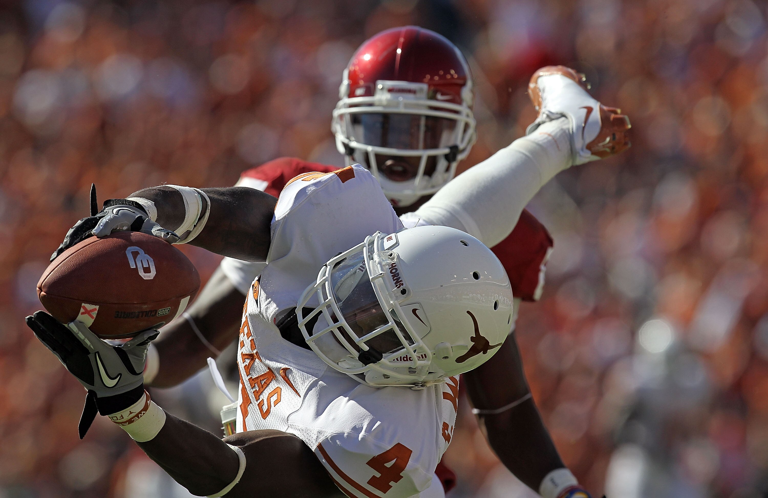 DALLAS - OCTOBER 02:  Cornerback Aaron Williams #4 of the Texas Longhorns drops a pass intended for Ryan Broyles #85 of the Oklahoma Sooners in the second quarter at the Cotton Bowl on October 2, 2010 in Dallas, Texas.  (Photo by Ronald Martinez/Getty Ima