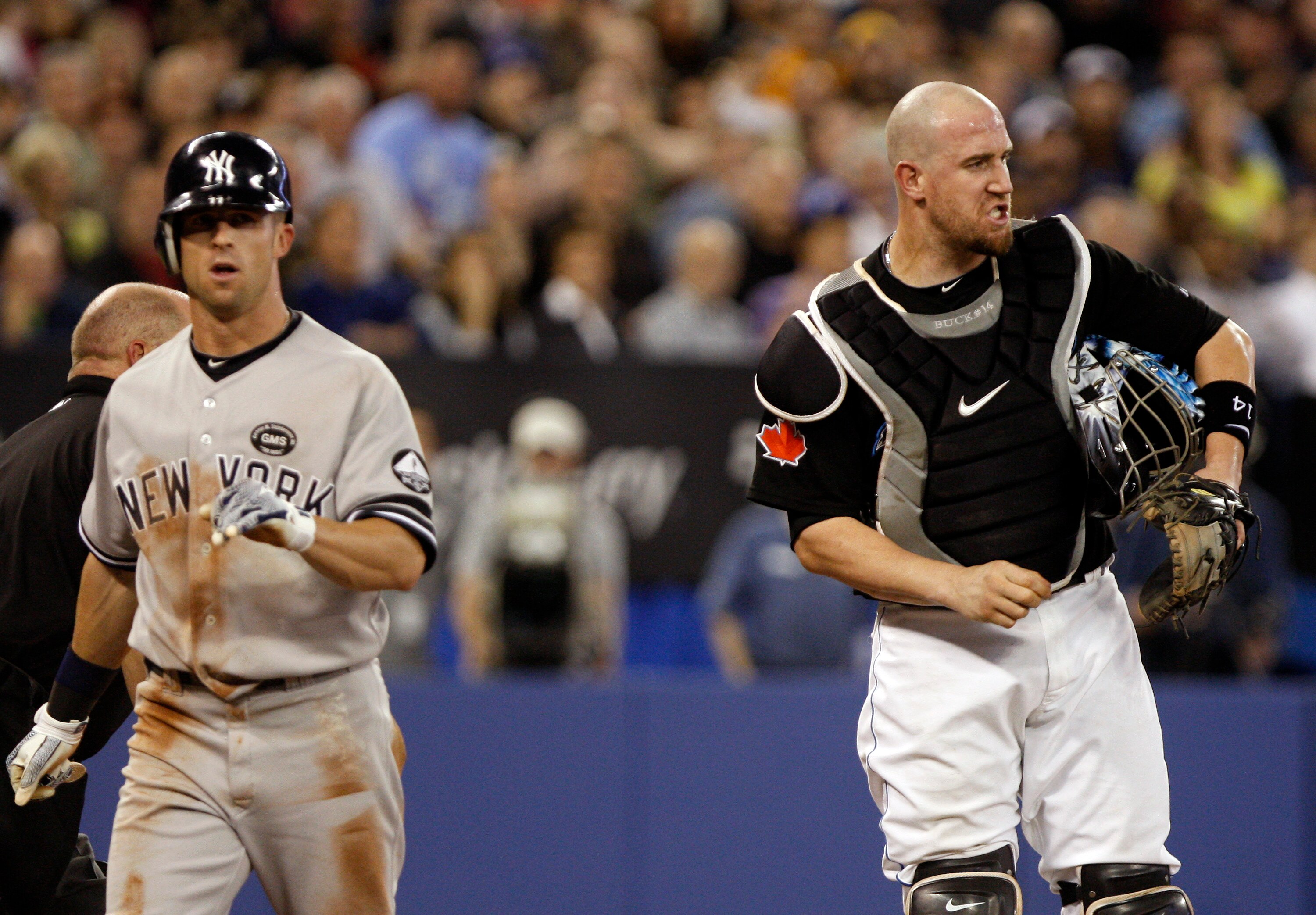 TORONTO, ON - SEPTEMBER 28: John Buck #14 of the Toronto Blue Jays reacts as Brett Gardner #11 of the New York Yankees is called safe at home during an MLB game at the Rogers Centre September 28, 2010 in Toronto, Ontario, Canada. (Photo by Abelimages/Gett