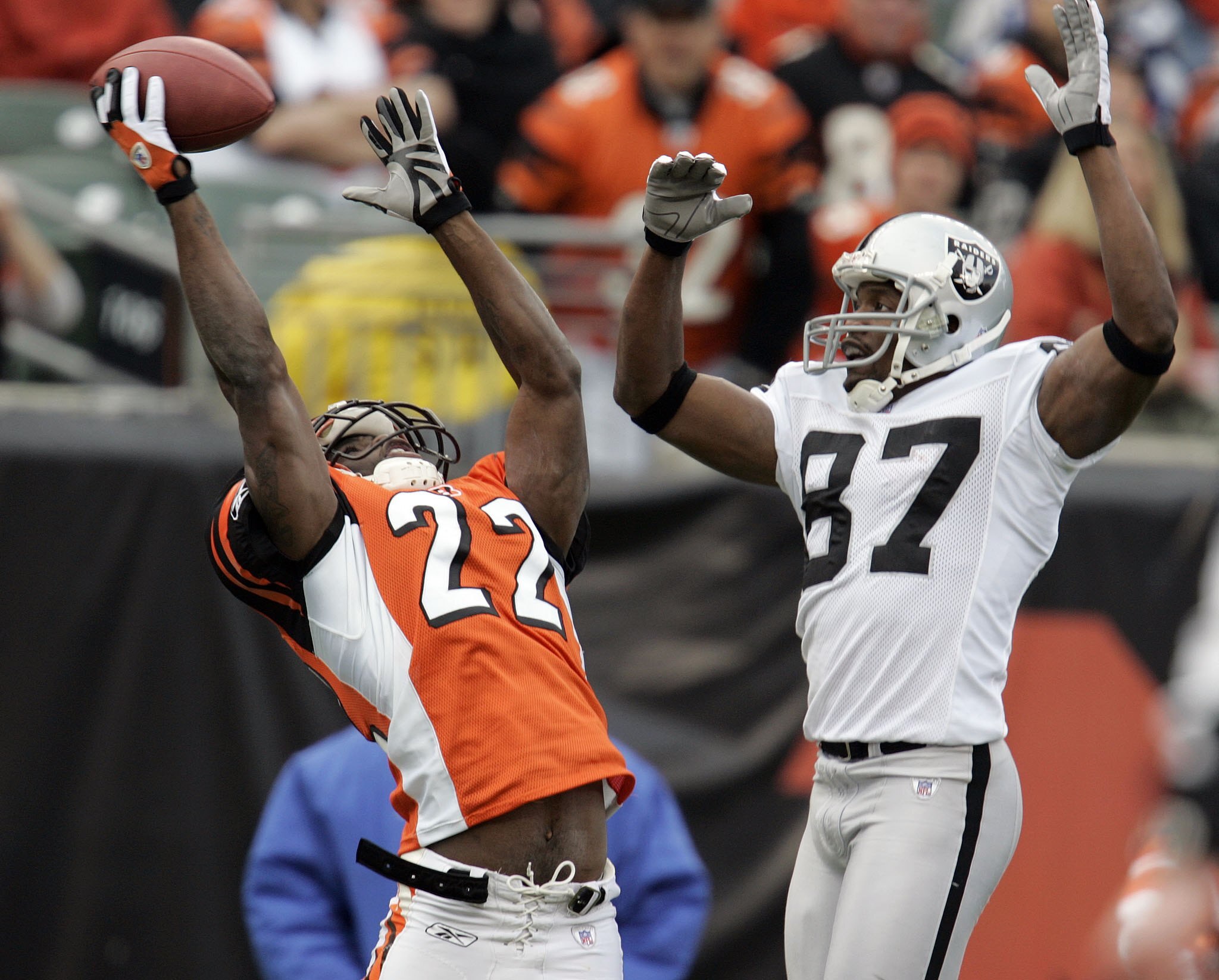 CINCINNATI, OH - DECEMBER 10:  Jonathan Joseph #22 of the Cincinnati Bengals almost intercepts a pass intended for Alvis Whitted #87 of the Oakland Raiders during the second quarter on December 10, 2006 at Paul Brown Stadium in Cincinnati, Ohio.  The Beng