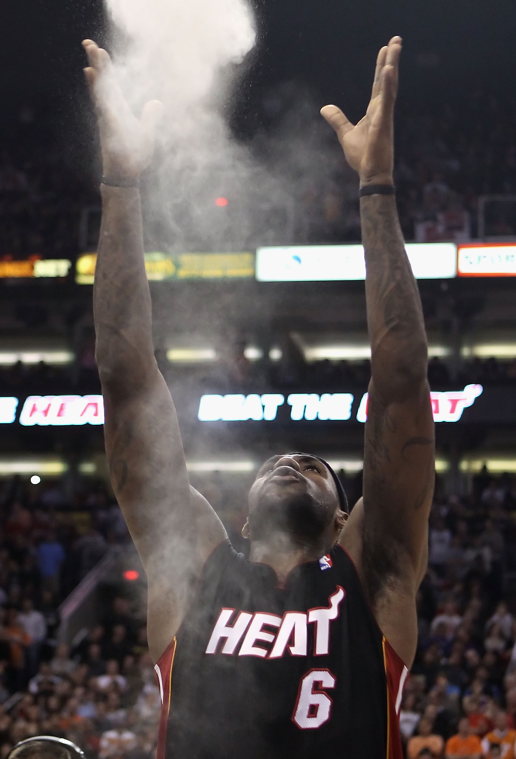 PHOENIX - DECEMBER 23:  LeBron James #6 of the Miami Heat throws chalk into the air before the NBA game against the Phoenix Suns at US Airways Center on December 23, 2010 in Phoenix, Arizona.  The Heat defeated the Suns 95-83.  NOTE TO USER: User expressl