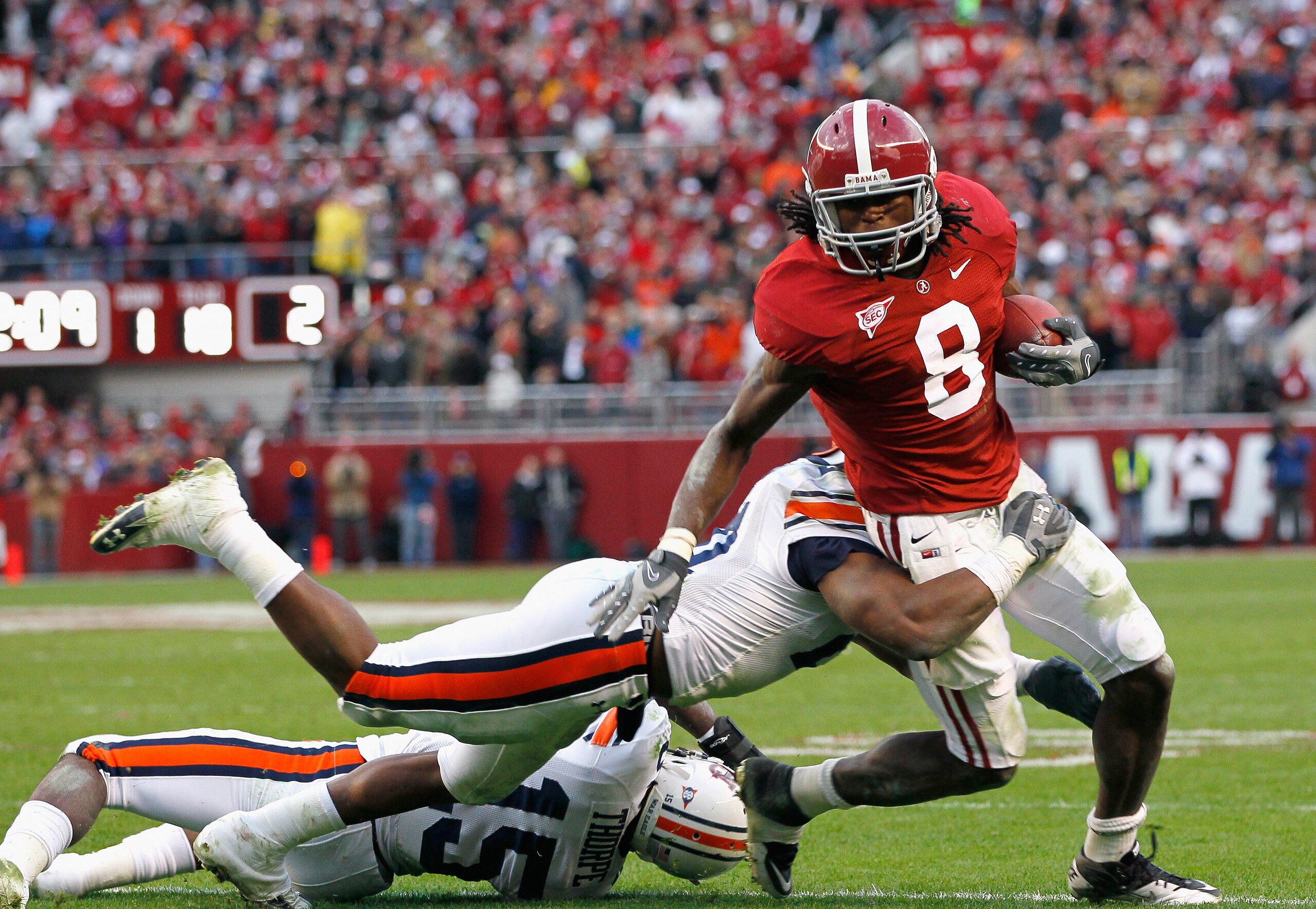TUSCALOOSA, AL - NOVEMBER 26: Julio Jones #8 of the Alabama Crimson Tide is tackled by Neiko Thorpe #15 and Eltoro Freeman #21 of the Auburn Tigers at Bryant-Denny Stadium on November 26, 2010 in Tuscaloosa, Alabama. (Photo by Kevin C. Cox/Getty Images) TUSCALOOSA, AL - NOVEMBER 26: Julio Jones #8 of the Alabama Crimson Tide is tackled by Neiko Thorpe #15 and Eltoro Freeman #21 of the Auburn Tigers at Bryant-Denny Stadium on November 26, 2010 in Tuscaloosa, Alabama. (Photo by Kevin C. Cox/Getty Images)