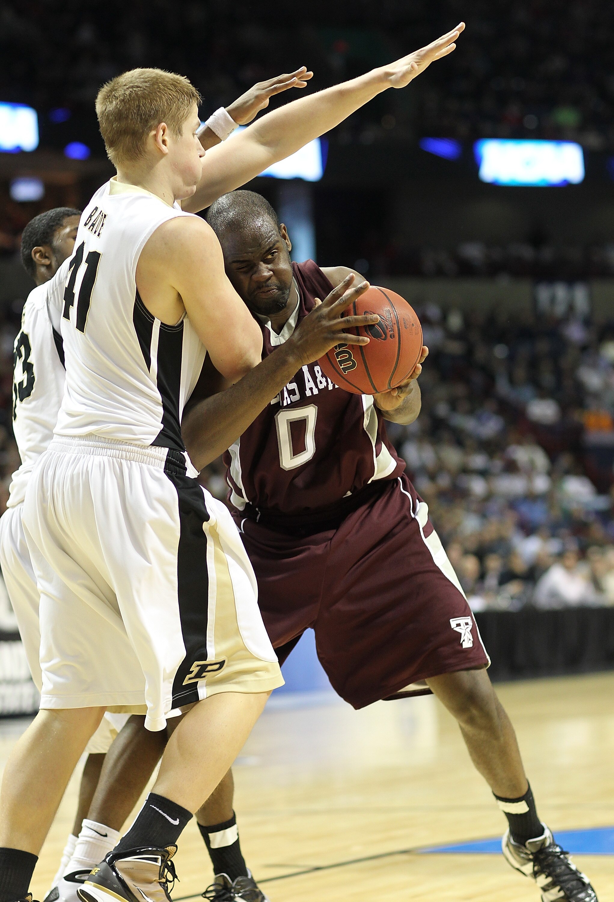 SPOKANE - MARCH 21:  Bryan Davis #0 of the Texas A&M  Aggies drives against Patrick Bade #41 of the Purdue Boilermakers during the second round of the 2010 NCAA men's basketball tournament at the Spokane Arena on March 21, 2010 in Spokane, Washington. (Ph