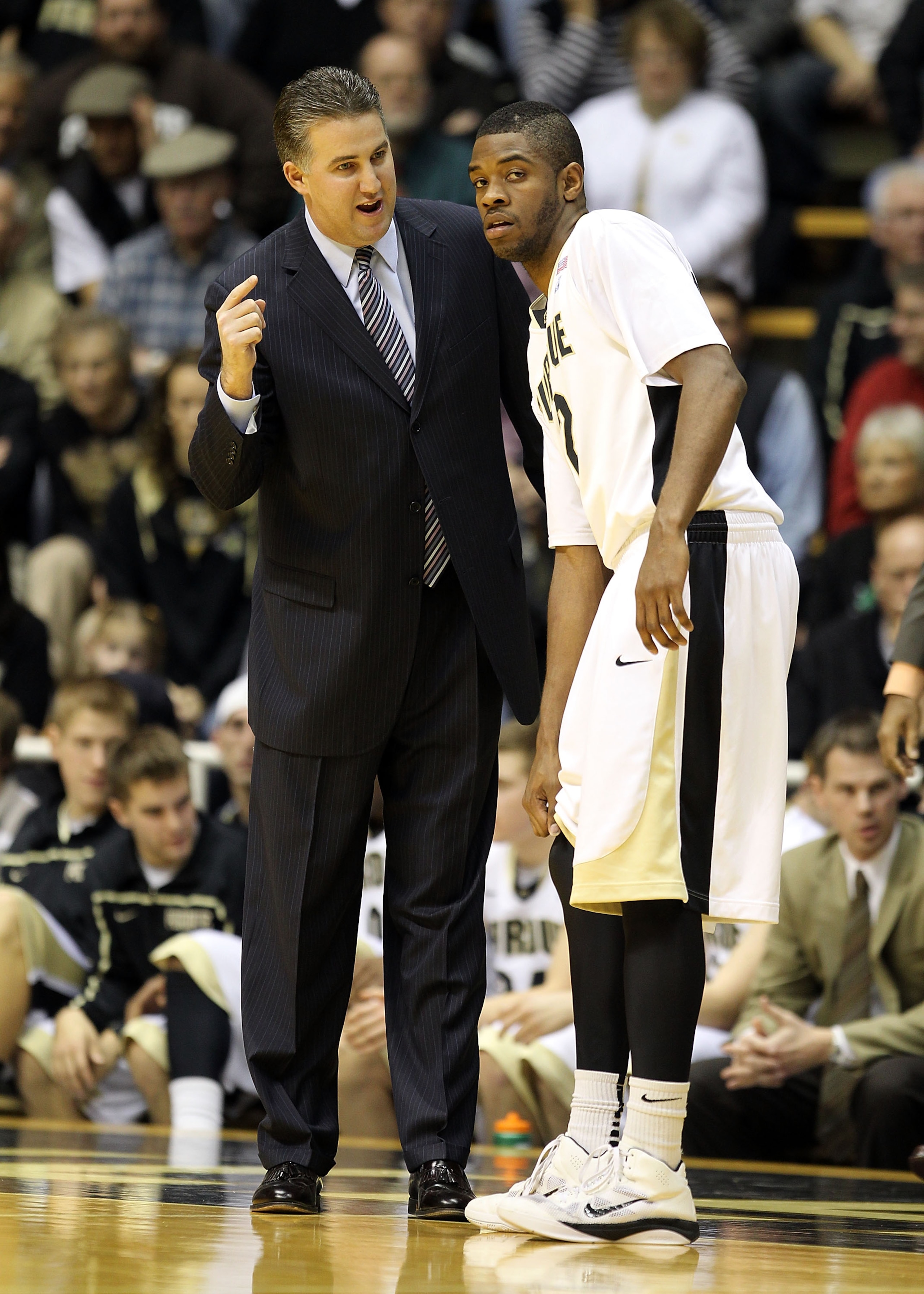 WEST LAFAYETTE, IN - DECEMBER 21:  Matt Painter the Head coach of the Purdue Boilermakers gives instructions to Kelsey Barlow #12 during the game against the IPFW Mastodons at Mackey Arena on December 21, 2010 in West Lafayette, Indiana.  (Photo by Andy L