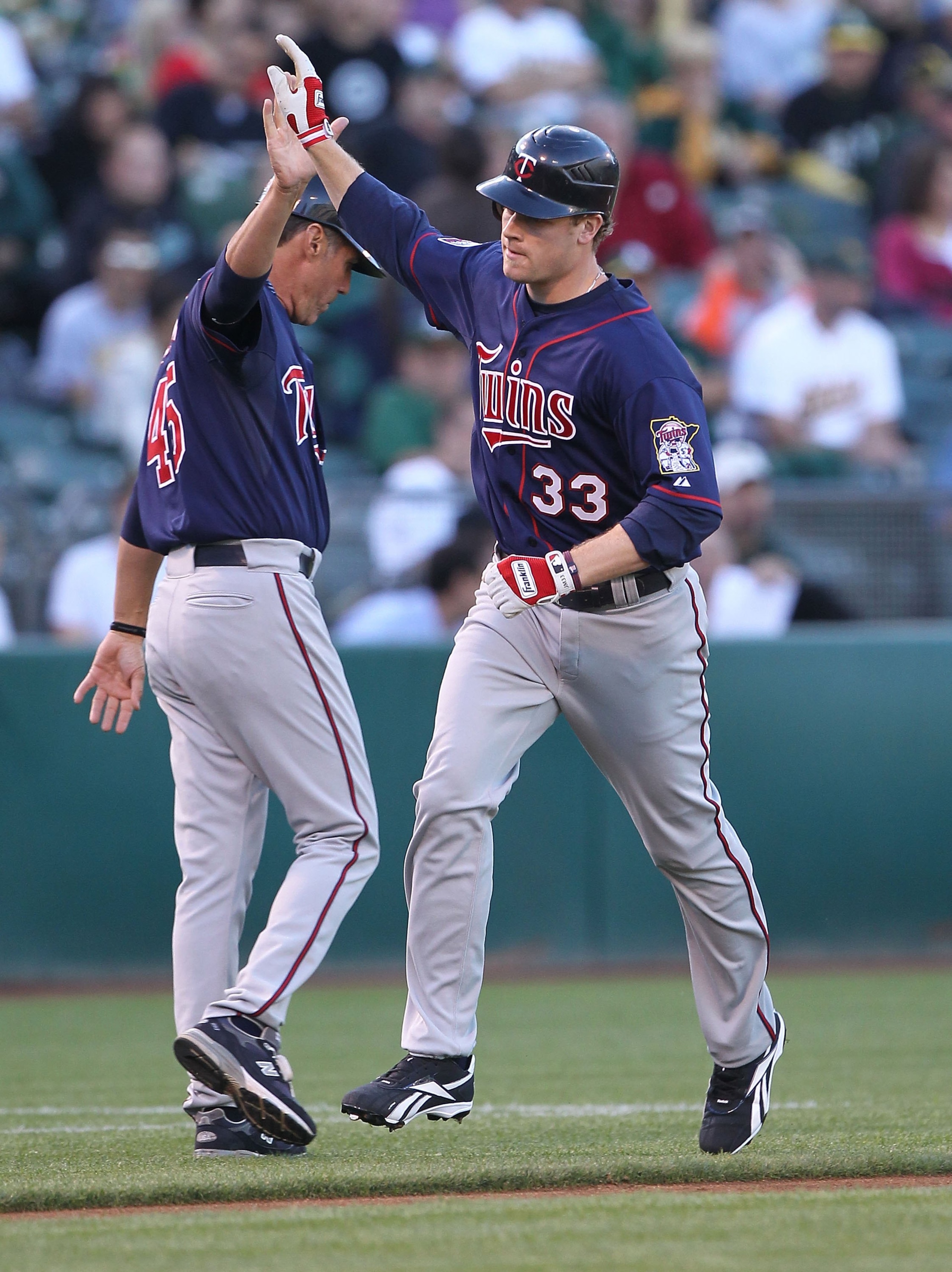 OAKLAND, CA - JUNE 04:  Justin Morneau #33 of the Minnesota Twins celebrates after hitting a two run home run against the Oakland Athletics in the first inning during an MLB game at the Oakland-Alameda County Coliseum on June 4, 2010 in Oakland, Californi
