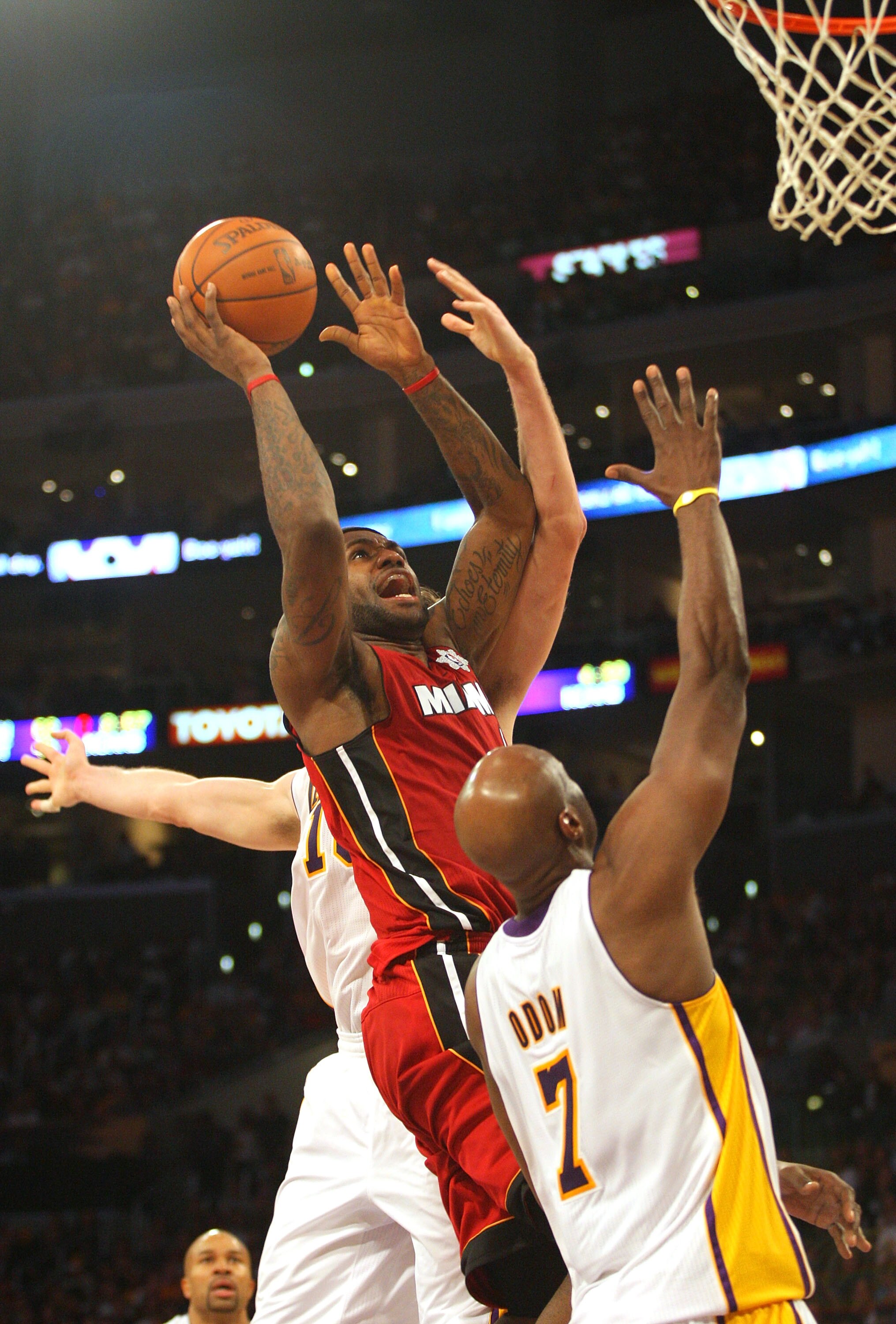 LOS ANGELES, CA - DECEMBER 25: LeBron James #6 of the Miami Heat goes for the jump shot against Lamar Odom #7 of the Los Angeles Lakers during the NBA game at Staples Center on December 25, 2010 in Los Angeles, California. The Heat defeated the Lakers 96-