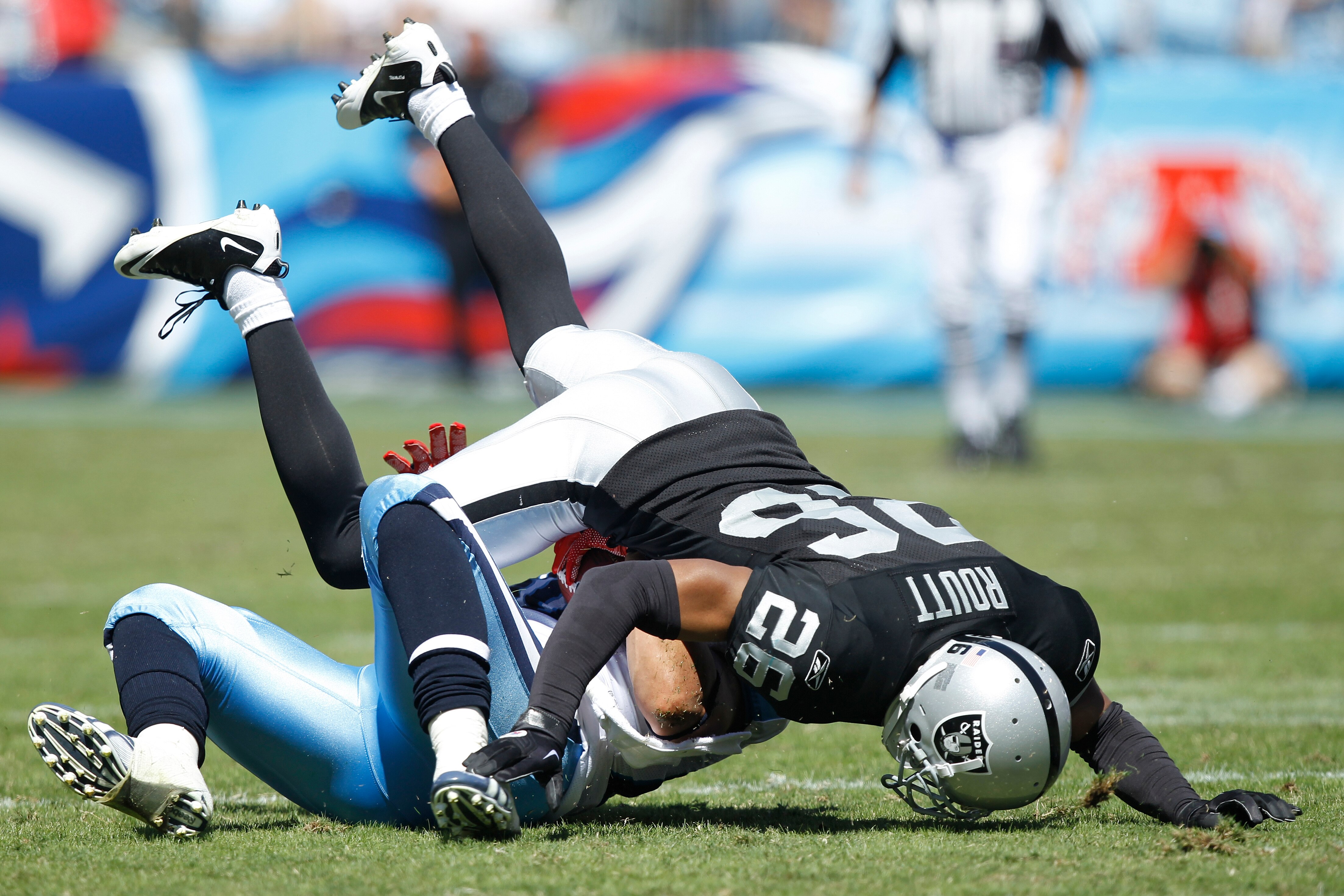 NASHVILLE - SEPTEMBER 12: Stanford Routt #26 of the Oakland Raiders tackles Bo Scaife #80 of the Tennessee Titans during the NFL season opener at LP Field on September 12, 2010 in Nashville, Tennessee. The Titans defeated the Raiders 38-13. (Photo by Joe