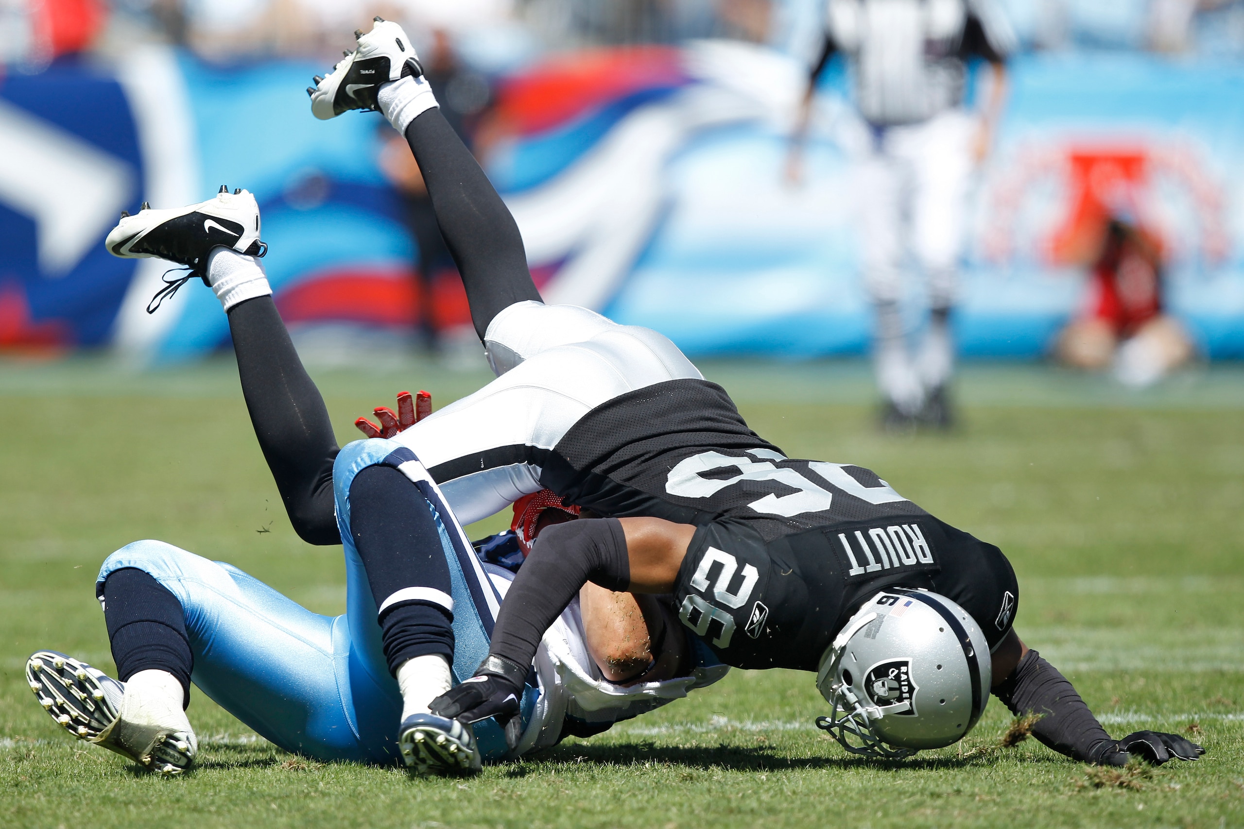NASHVILLE - SEPTEMBER 12: Stanford Routt #26 of the Oakland Raiders tackles Bo Scaife #80 of the Tennessee Titans during the NFL season opener at LP Field on September 12, 2010 in Nashville, Tennessee. The Titans defeated the Raiders 38-13. (Photo by Joe