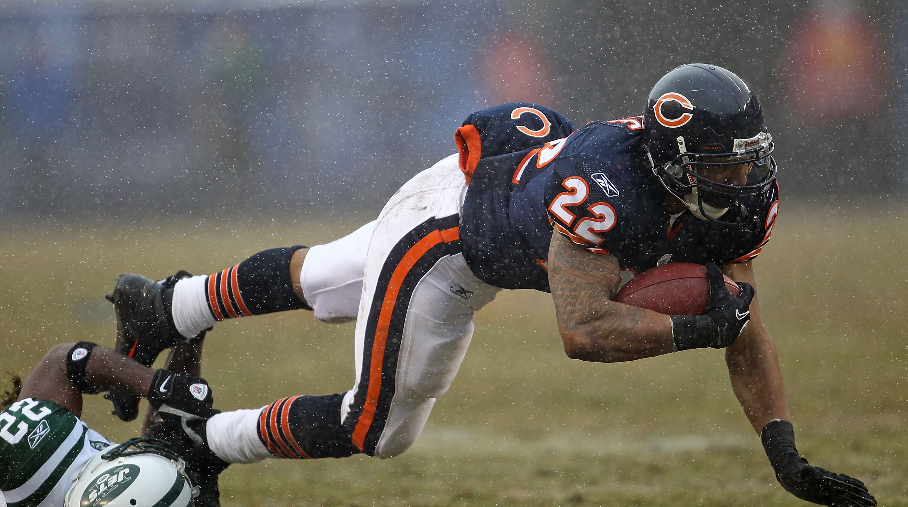 CHICAGO, IL - DECEMBER 26: Matt Forte #22 of the Chicago Bears is tripped up by Brodney Pool #22 of the New York Jets at Soldier Field on December 26, 2010 in Chicago, Illinois. The Bears defeated the Jets 38-34. (Photo by Jonathan Daniel/Getty Images)