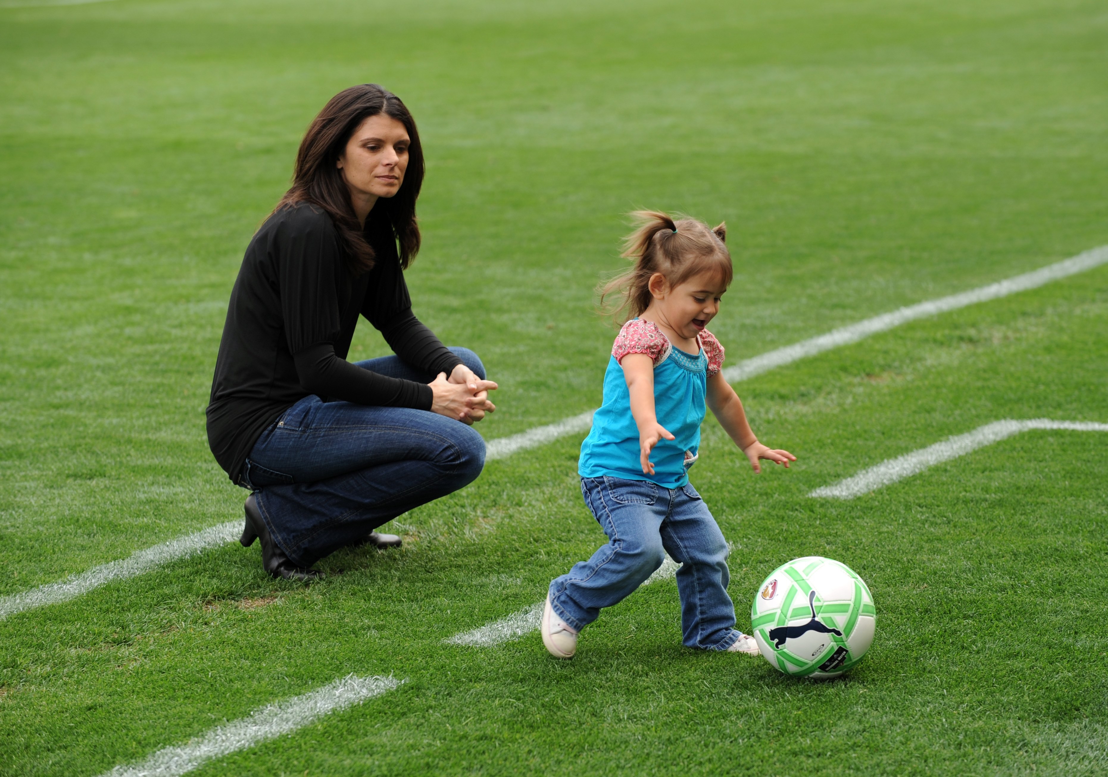 CARSON, CA - MARCH 29:  Mia Hamm watches her daughter play with a ball prior to the match between the Washington Freedom and the Los Angeles Sol at The Home Depot Center on March 29, 2009 in Carson, California. The Sol defeated the Freedom 2-0. (Photo by