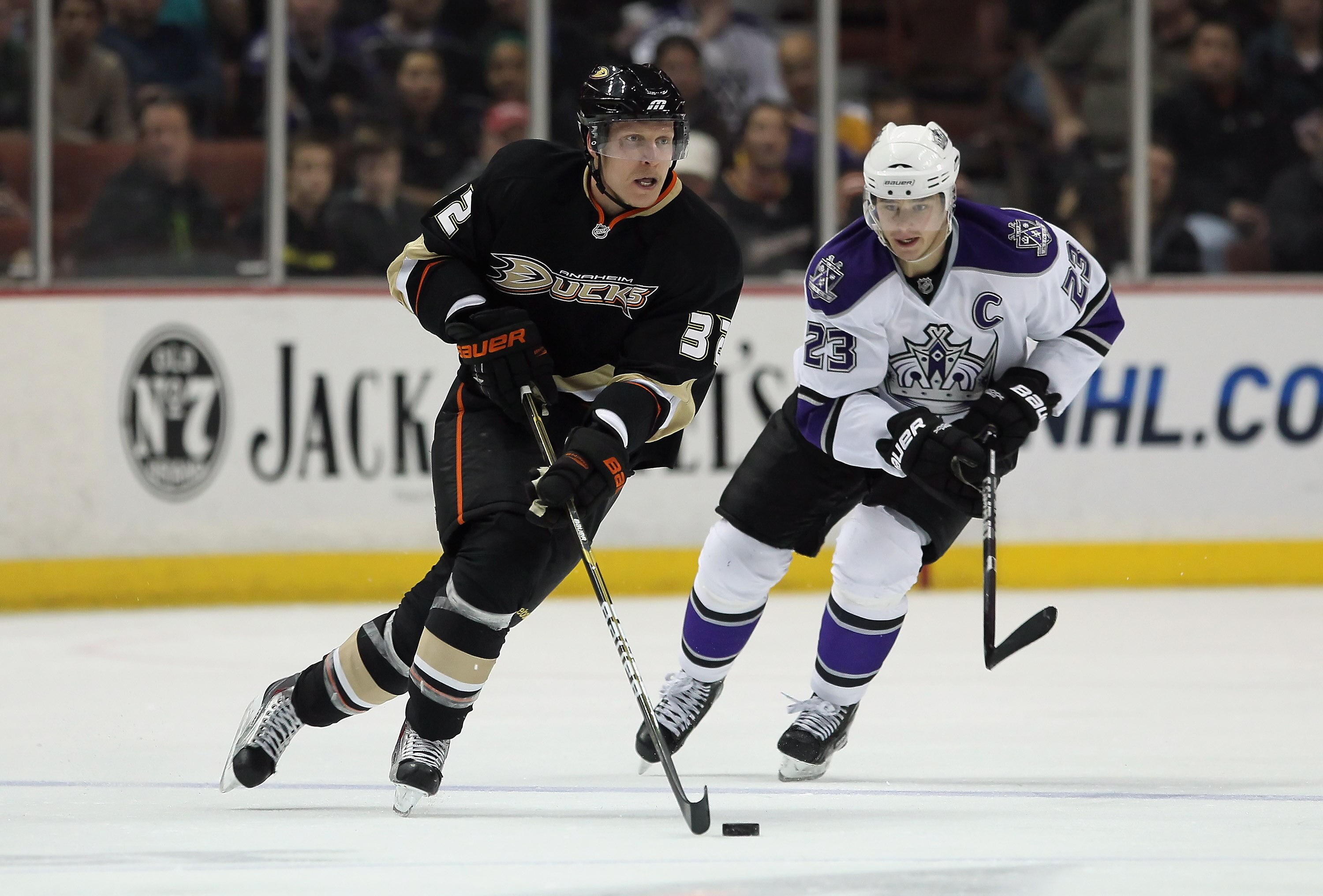 ANAHEIM, CA - NOVEMBER 29:  Toni Lydman #32 of the Anaheim Ducks is pursued by Dustin Brown #23 of the Los Angeles Kings during the third period at the Honda Center on November 29, 2010 in Anaheim, California. The Ducks defeated the Kings 2-0.  (Photo by