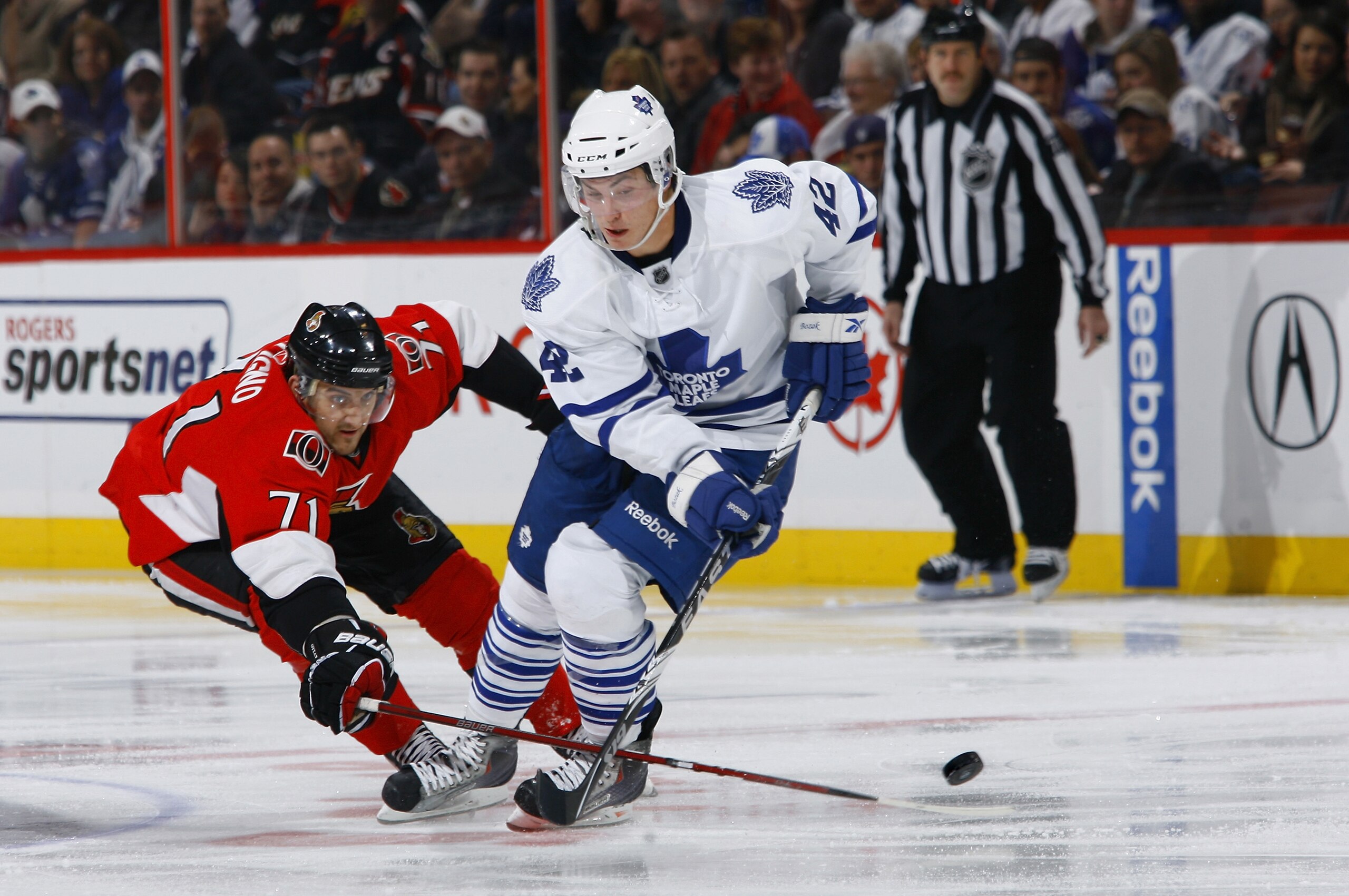 OTTAWA, ON - NOVEMBER 27:  Nick Foligno #71 of the Ottawa Senators pokes the puck away from Tyler Bozak #42 of the Toronto Maple Leafs in a game at Scotiabank Place on November 27, 2010 in Ottawa, Ontario, Canada.  (Photo by Phillip MacCallum/Getty Images