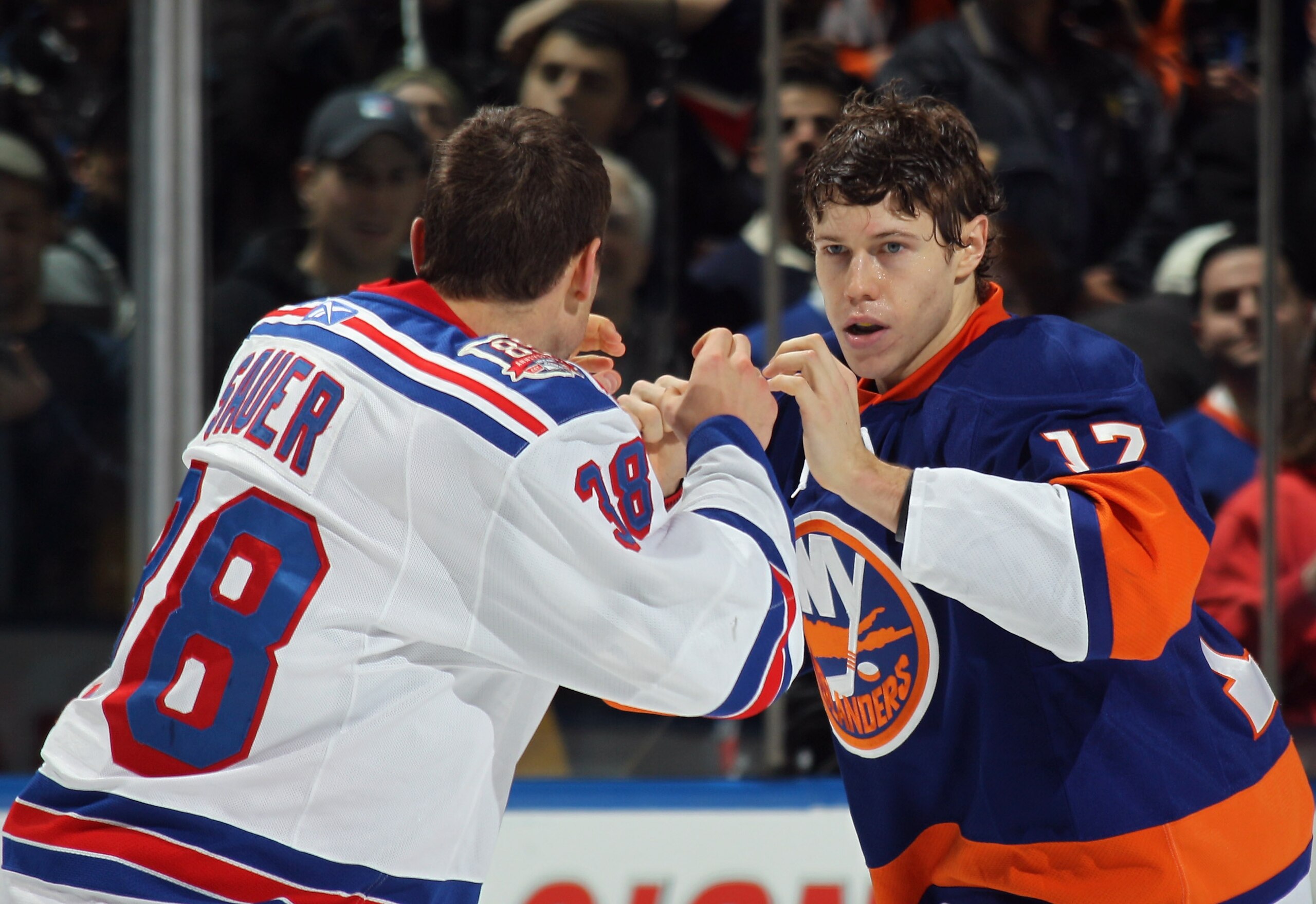 UNIONDALE, NY - DECEMBER 02: Michael Sauer #38 of the New York Rangers fights with Matt Martin #17 of the New York Islanders at the Nassau Coliseum on December 2, 2010 in Uniondale, New York.  (Photo by Bruce Bennett/Getty Images)