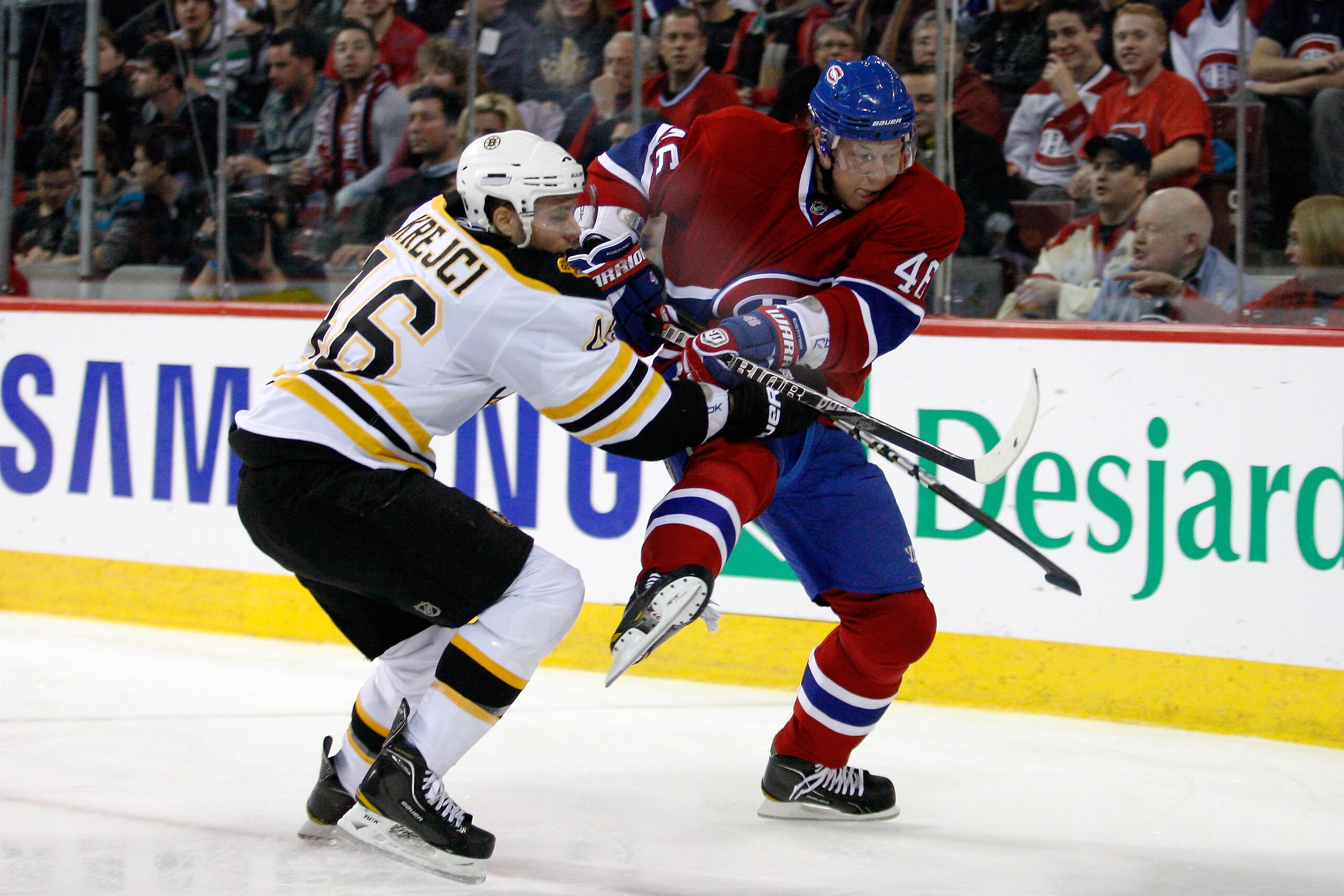 MONTREAL, CANADA - DECEMBER 16:  Andrei Kostitsyn #46 of the Montreal Canadiens and David Krejci #46 of the Boston Bruins chase the puck into the corner during the NHL game at the Bell Centre on December 16, 2010 in Montreal, Quebec, Canada.  The Canadien