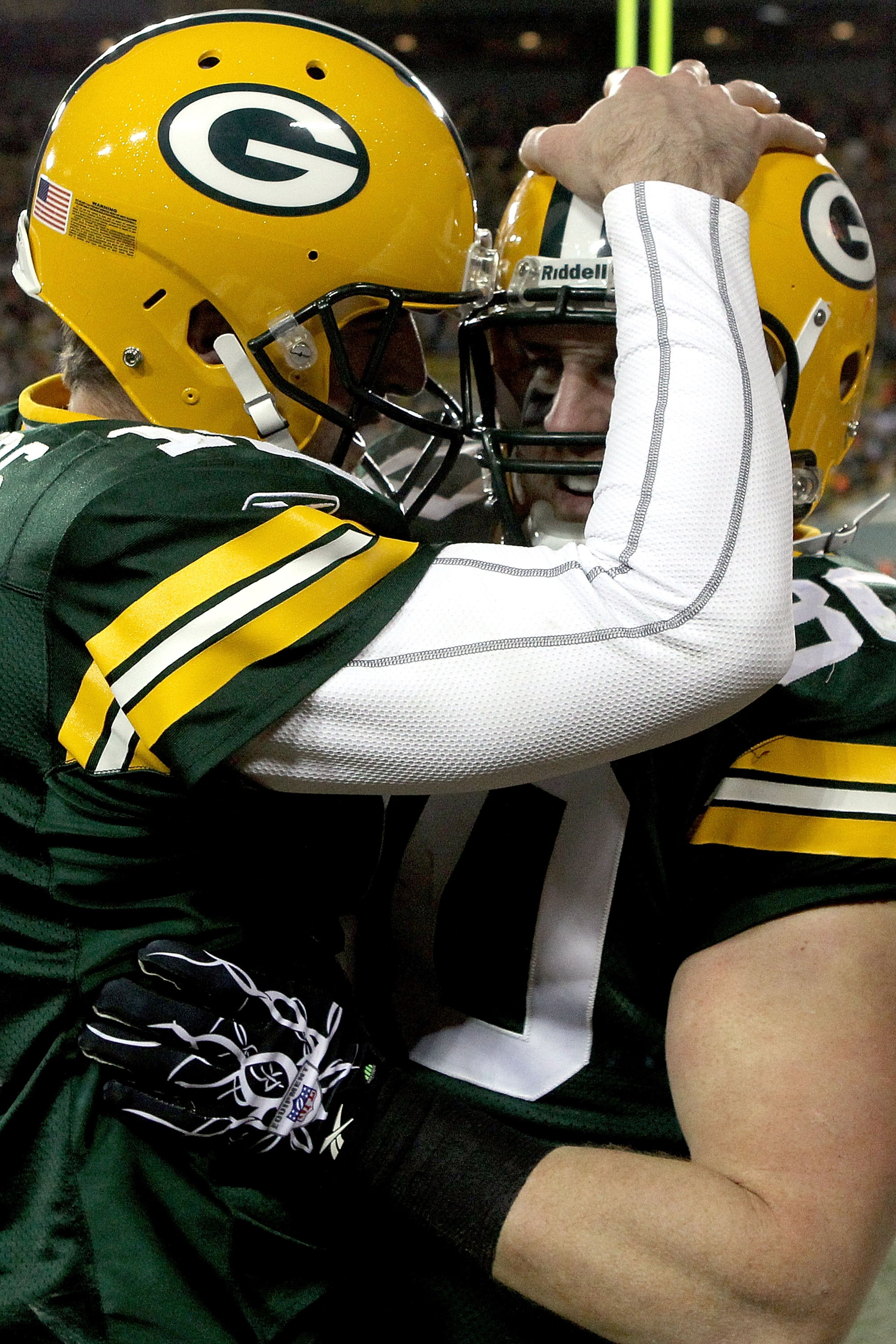 GREEN BAY, WI - DECEMBER 26:  Aaron Rodgers #12 of the Green Bay Packers is celebrates a John Kuhn #30 touchdown against the New York Giants at Lambeau Field on December 26, 2010 in Green Bay, Wisconsin.  (Photo by Matthew Stockman/Getty Images)