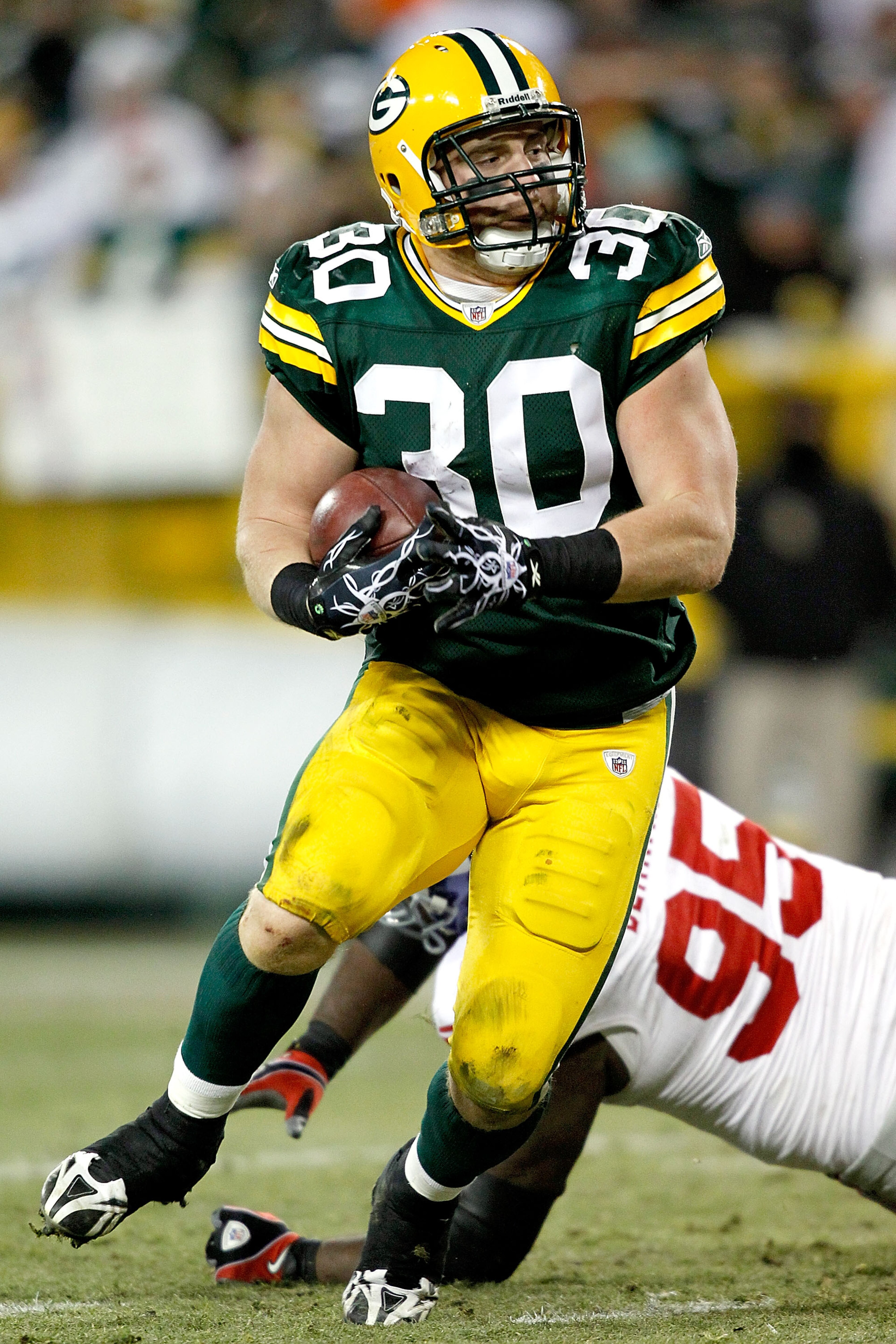 GREEN BAY, WI - DECEMBER 26:  John Kuhn #30 of the Green Bay Packers carries the ball for a touchdown against the New York Giants at Lambeau Field on December 26, 2010 in Green Bay, Wisconsin.  (Photo by Matthew Stockman/Getty Images)