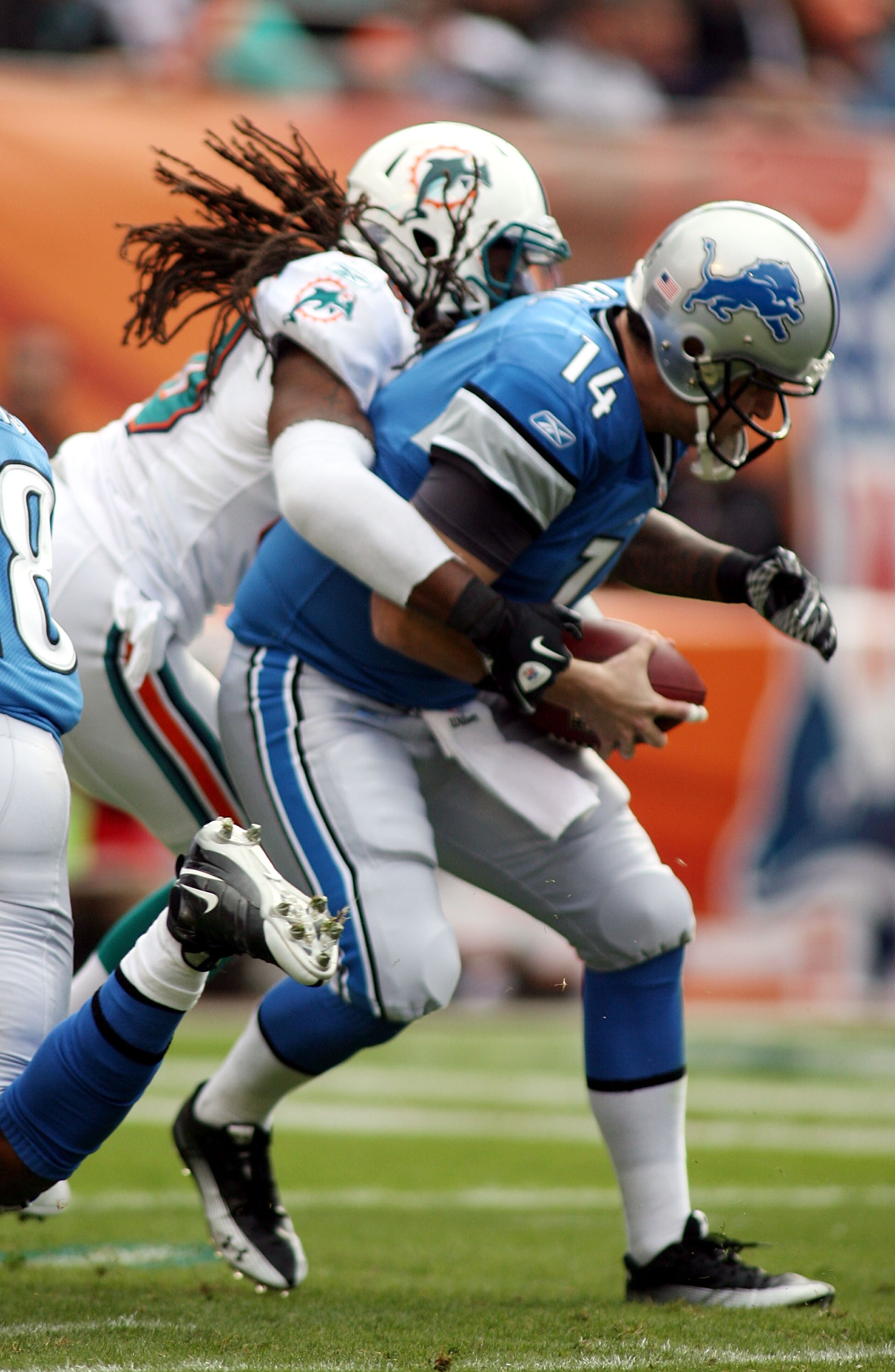 MIAMI - DECEMBER 26: Quarterback Shaun Hill #14 of the Detroit Lions is sacked by Chris Clemons #30 of the Miami Dolphins at Sun Life Stadium on December 26, 2010 in Miami, Florida.  (Photo by Marc Serota/Getty Images)