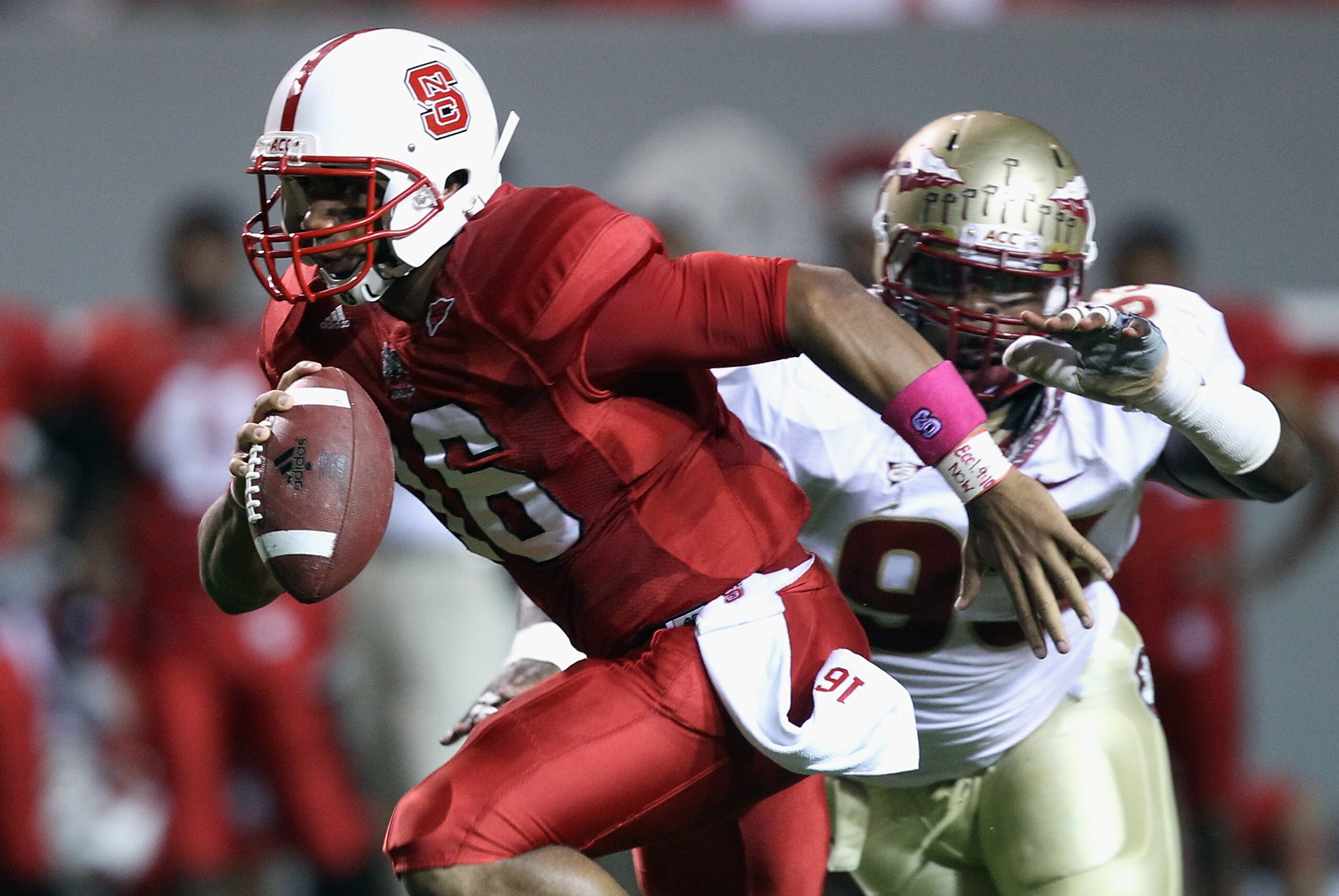 RALEIGH, NC - OCTOBER 28:  Everett Dawkins #93 of the Florida State Seminoles chases Russell Wilson #16 of the North Carolina State Wolfpack during their game at Carter-Finley Stadium on October 28, 2010 in Raleigh, North Carolina.  (Photo by Streeter Lec