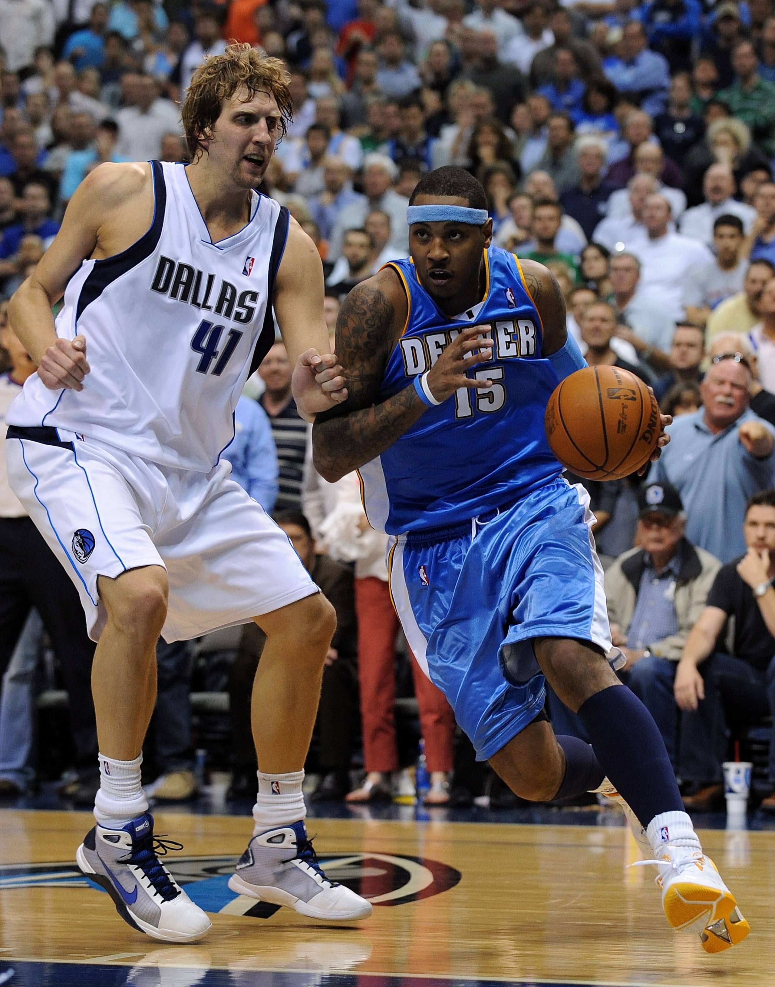 DALLAS - MAY 11:  Forward Carmelo Anthony #15 of the Denver Nuggets dribbles the ball past Dirk Nowitzki #41 of the Dallas Mavericks in Game Four of the Western Conference Semifinals during the 2009 NBA Playoffs at American Airlines Center on May 11, 2009
