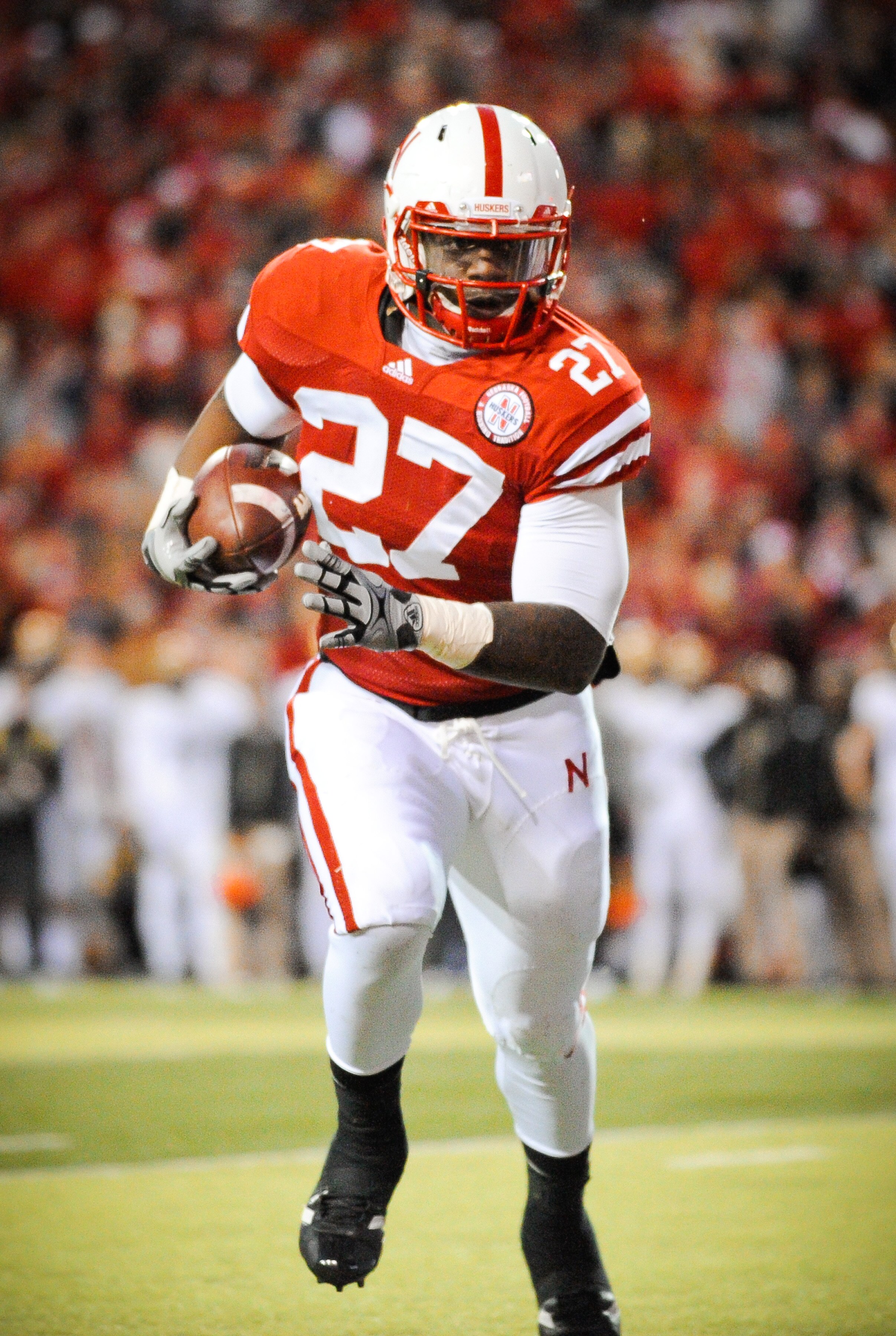 LINCOLN, NE - NOVEMBER 26: Dontrayevous Robinson #27 of the Nebraska Cornhuskers runs for the endzone during their game against the Colorado Buffaloes at Memorial Stadium on November 26, 2010 in Lincoln, Nebraska. Nebraska defeated Colorado 45-17 (Photo b