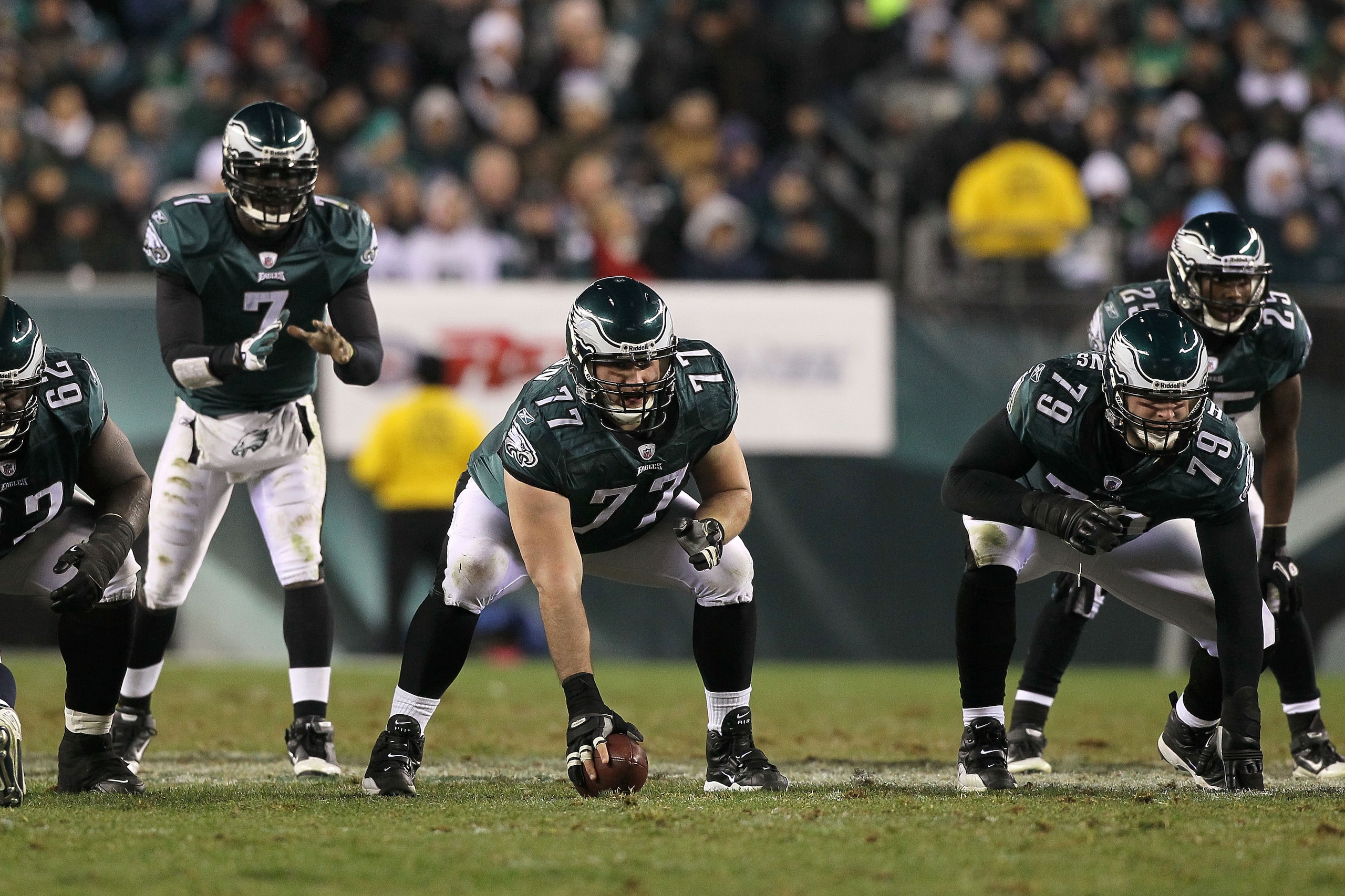 PHILADELPHIA, PA - DECEMBER 02:  Mike McGlynn #77 of the Philadelphia Eagles gets set to snap the ball to quarterback Michael Vick #7 in the shotgun formation against the Houston Texans at Lincoln Financial Field on December 2, 2010 in Philadelphia, Penns