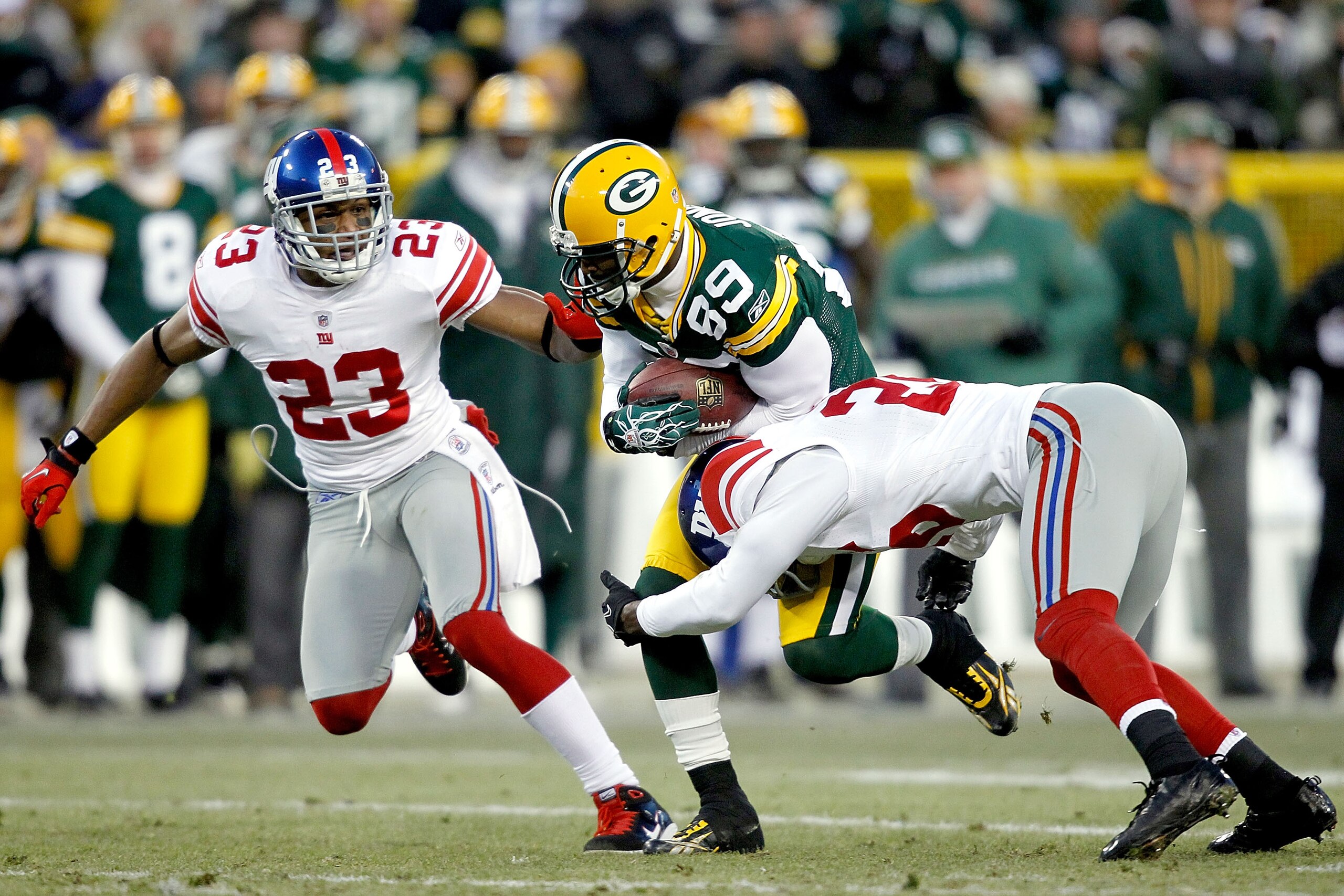 GREEN BAY, WI - DECEMBER 26:  James Jones #89 of the Green Bay Packers is tackled by Antrel Rolle #26 of the New York Giants at Lambeau Field on December 26, 2010 in Green Bay, Wisconsin.  (Photo by Matthew Stockman/Getty Images)