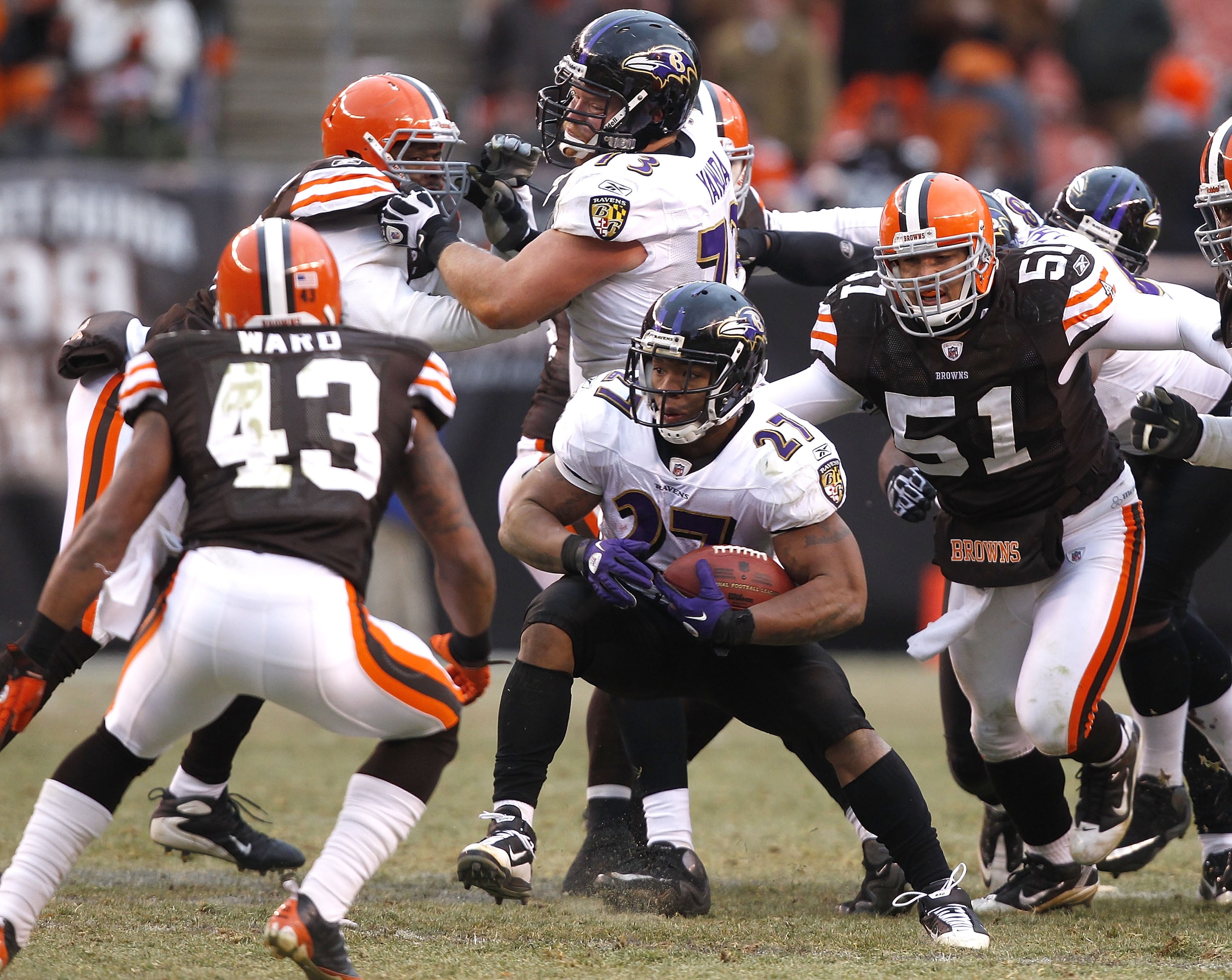 CLEVELAND - DECEMBER 26:  Running back Ray Rice #27 of the Baltimore Ravens runs by defenders T.J. Ward #43 and Chris Gocong #51 of the Cleveland Browns at Cleveland Browns Stadium on December 26, 2010 in Cleveland, Ohio.  (Photo by Matt Sullivan/Getty Im