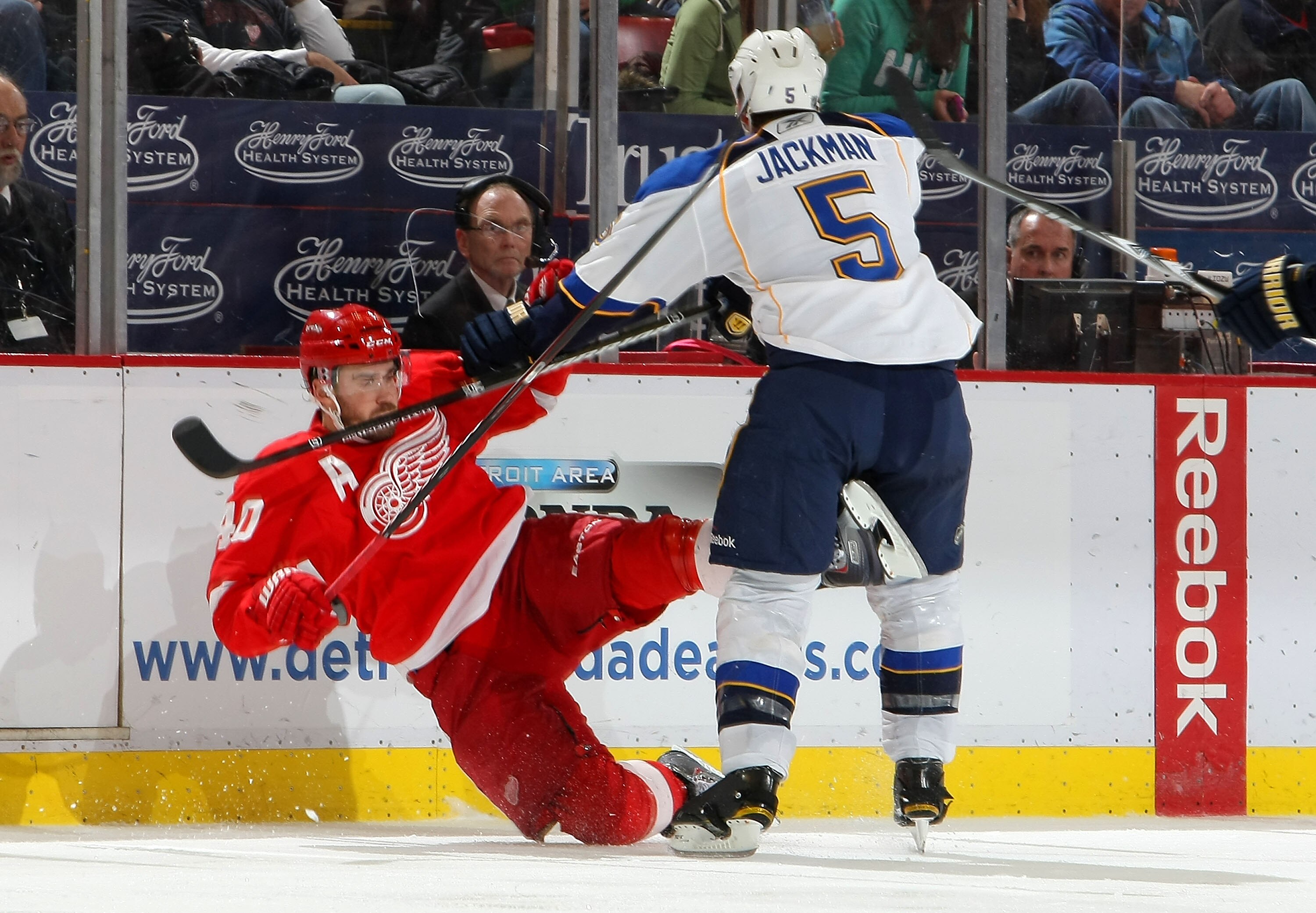 DETROIT, MI - DECEMBER 15:  Henrik Zetterberg #40 of the Detroit Red Wings is checked by Barret Jackman #5 of the St.Louis Blues during their NHL game at Joe Louis Arena on December 15, 2010 in Detroit, Michigan.(Photo By Dave Sandford/Getty Images)