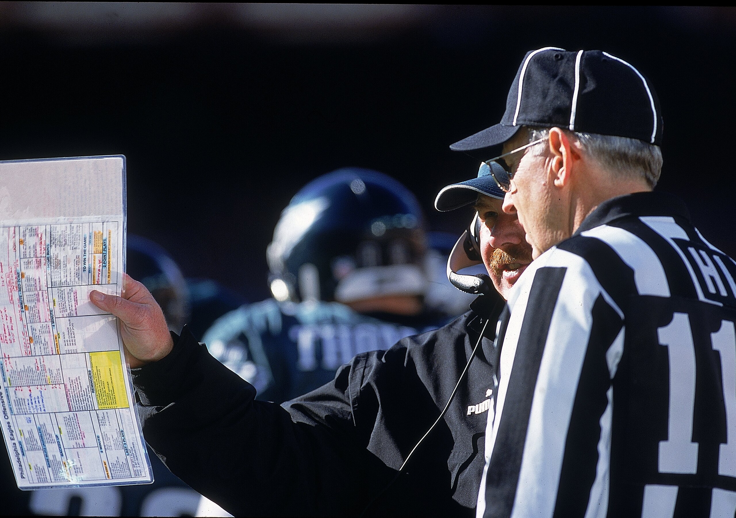 26 Nov 2000:  Head Coach Andy Reid of the Philadelphia Eagles shows the referee his playbook during the game against the Washington Redskins at the FedEx Field in Landover, Maryland. The Eagles defeated the Redskins 23-20.Mandatory Credit: Jamie Squire  /