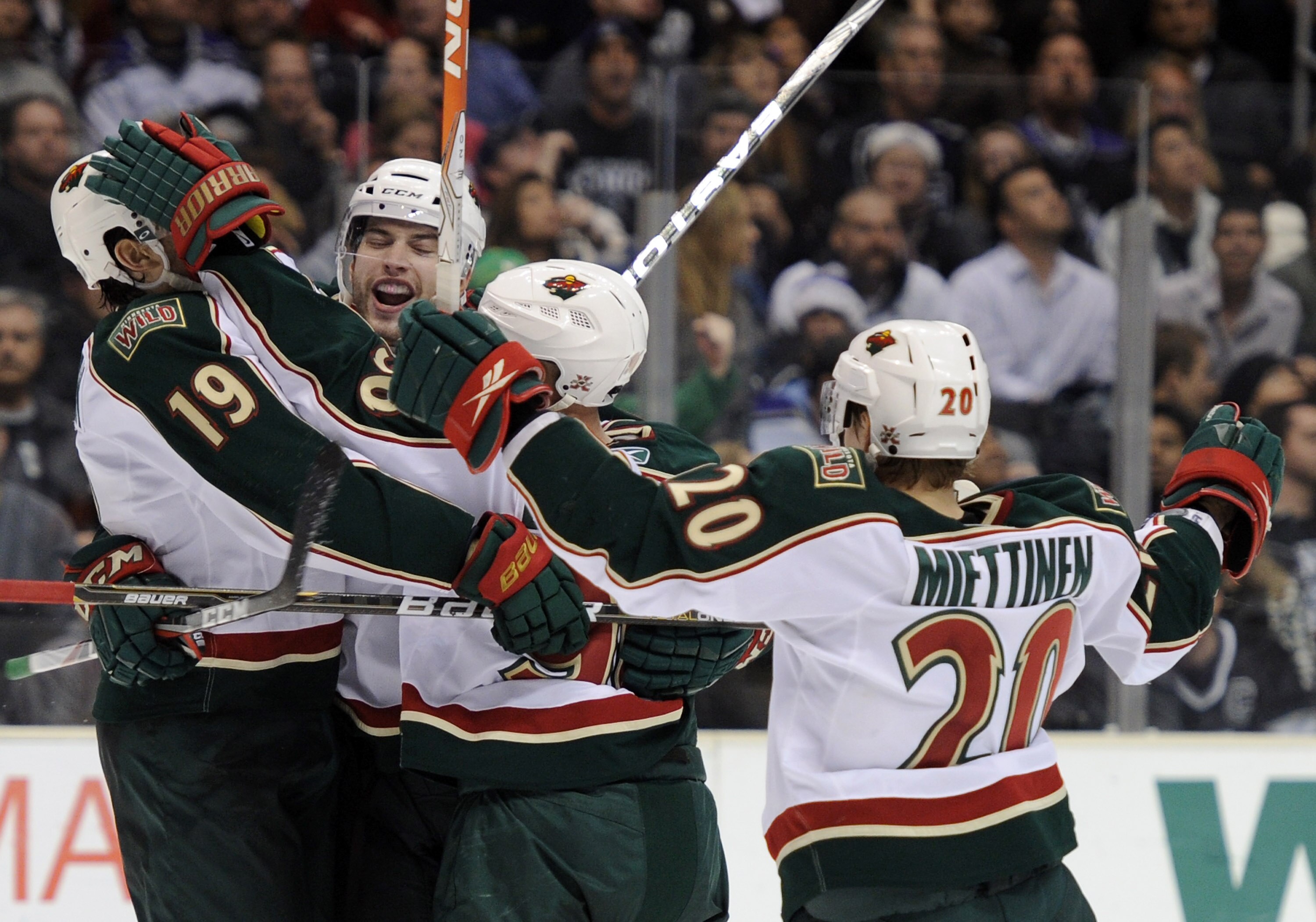 LOS ANGELES, CA - DECEMBER 11:  Brent Burns #8 of the Minnesota Wild celebrates his overtimes goal with teammates Patrick O'Sullivan #19, Pierre-Marc Bouchard #96 and Antti Miettinen #20 for a 3-2 win over the Los Angeles Kings at the Staples Center on De