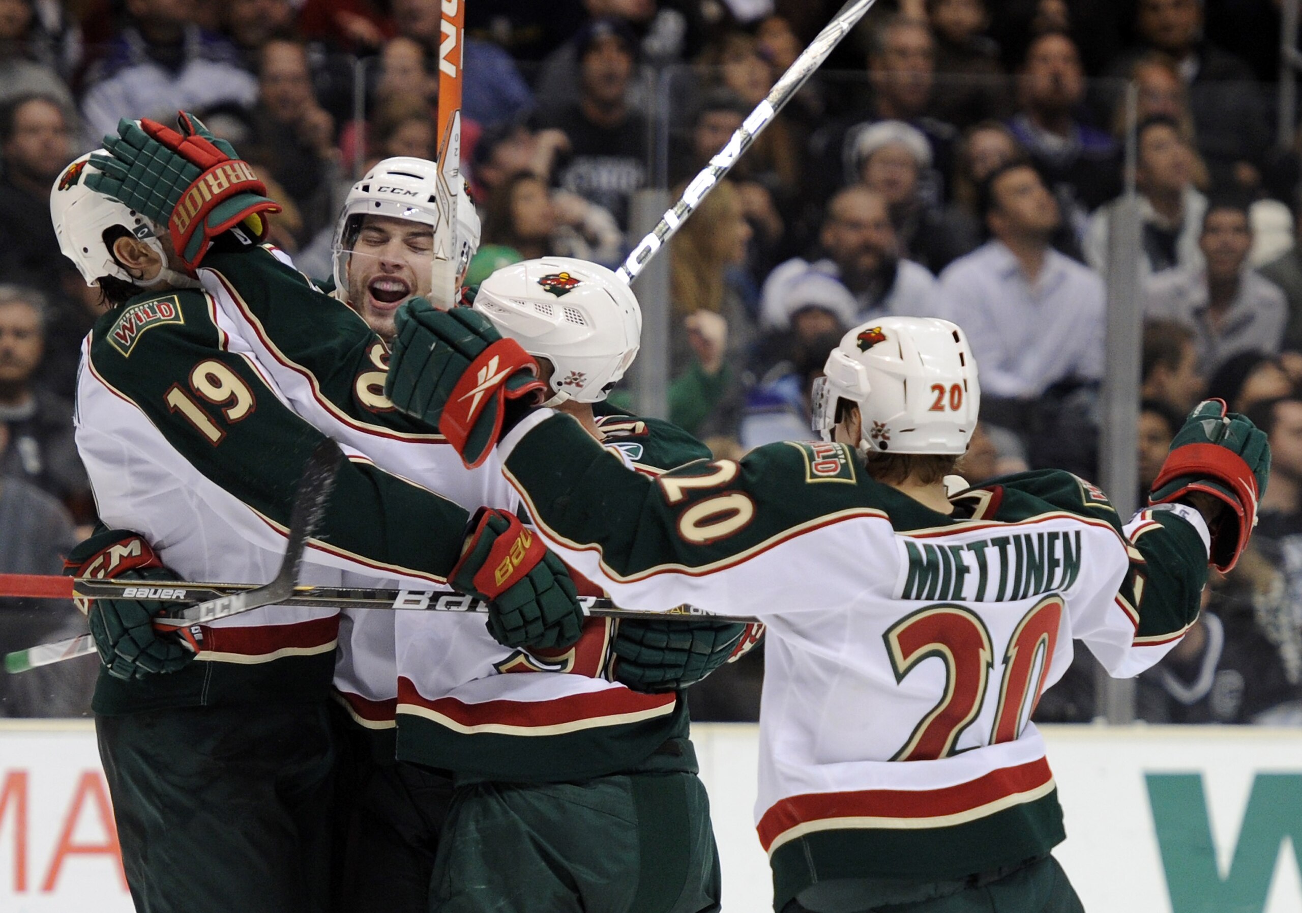 LOS ANGELES, CA - DECEMBER 11:  Brent Burns #8 of the Minnesota Wild celebrates his overtimes goal with teammates Patrick O'Sullivan #19, Pierre-Marc Bouchard #96 and Antti Miettinen #20 for a 3-2 win over the Los Angeles Kings at the Staples Center on De