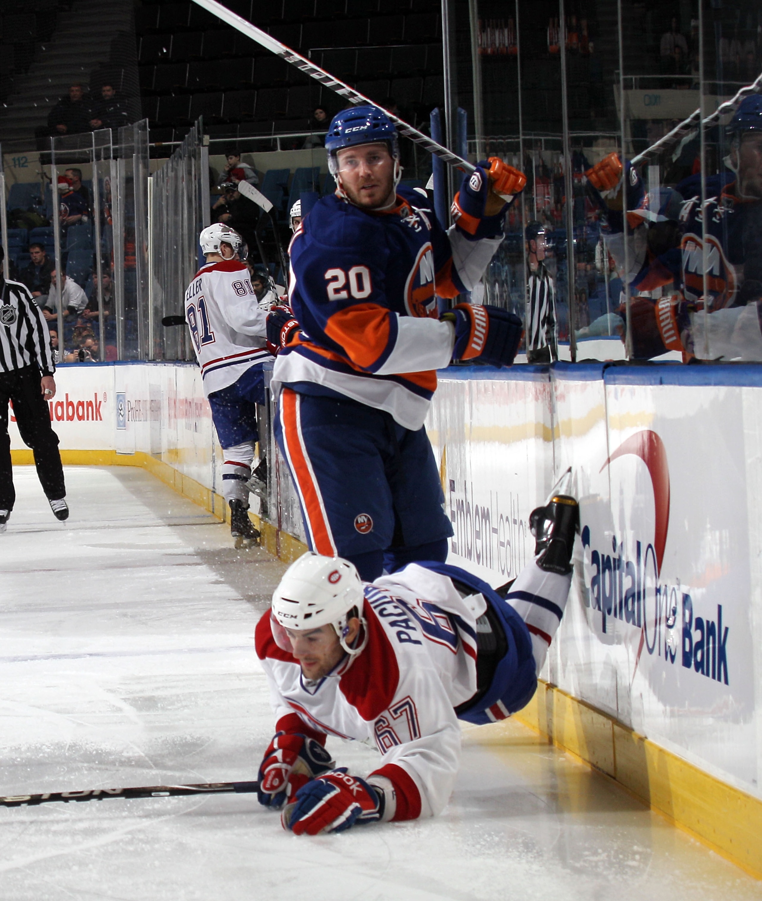 UNIONDALE, NY - DECEMBER 26: Max Pacioretty #67 of the Montreal Canadiens is tripped up by James Wisniewski #20 of the New York Islanders at the Nassau Coliseum on December 26, 2010 in Uniondale, New York.  (Photo by Bruce Bennett/Getty Images)