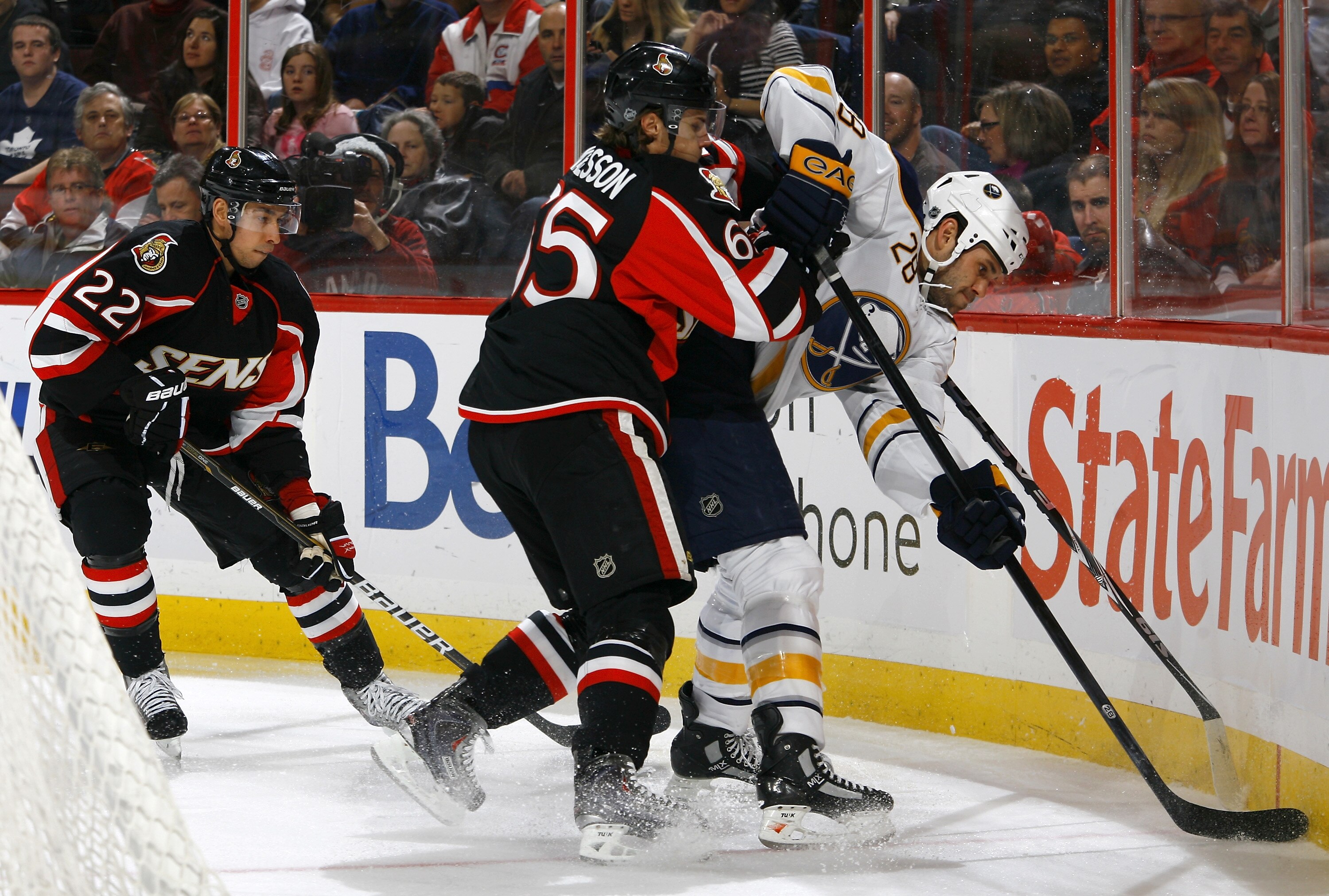 OTTAWA, ON - DECEMBER 04:  Erik Karlsson #65 of the Ottawa Senators battles with Paul Gaustad #28 of the Buffalo Sabres in behind the net in a game at Scotiabank Place on December 4, 2010 in Ottawa, Ontario, Canada.  The Buffalo Sabres defeated the Ottawa