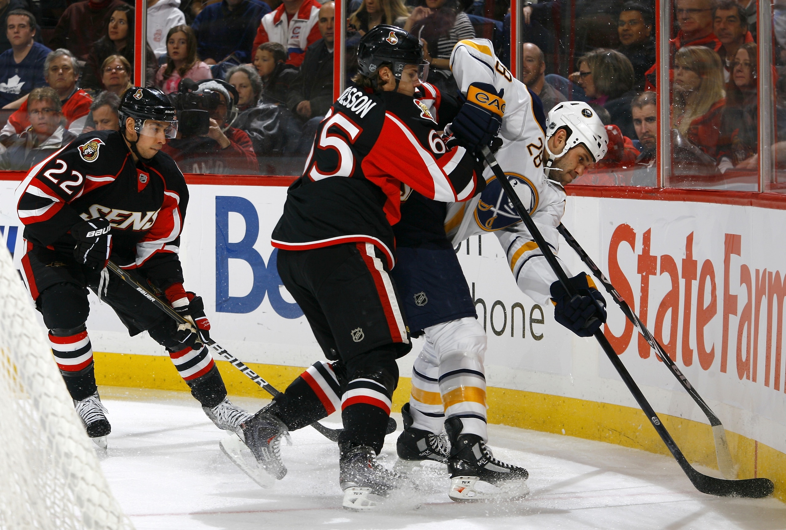 OTTAWA, ON - DECEMBER 04:  Erik Karlsson #65 of the Ottawa Senators battles with Paul Gaustad #28 of the Buffalo Sabres in behind the net in a game at Scotiabank Place on December 4, 2010 in Ottawa, Ontario, Canada.  The Buffalo Sabres defeated the Ottawa
