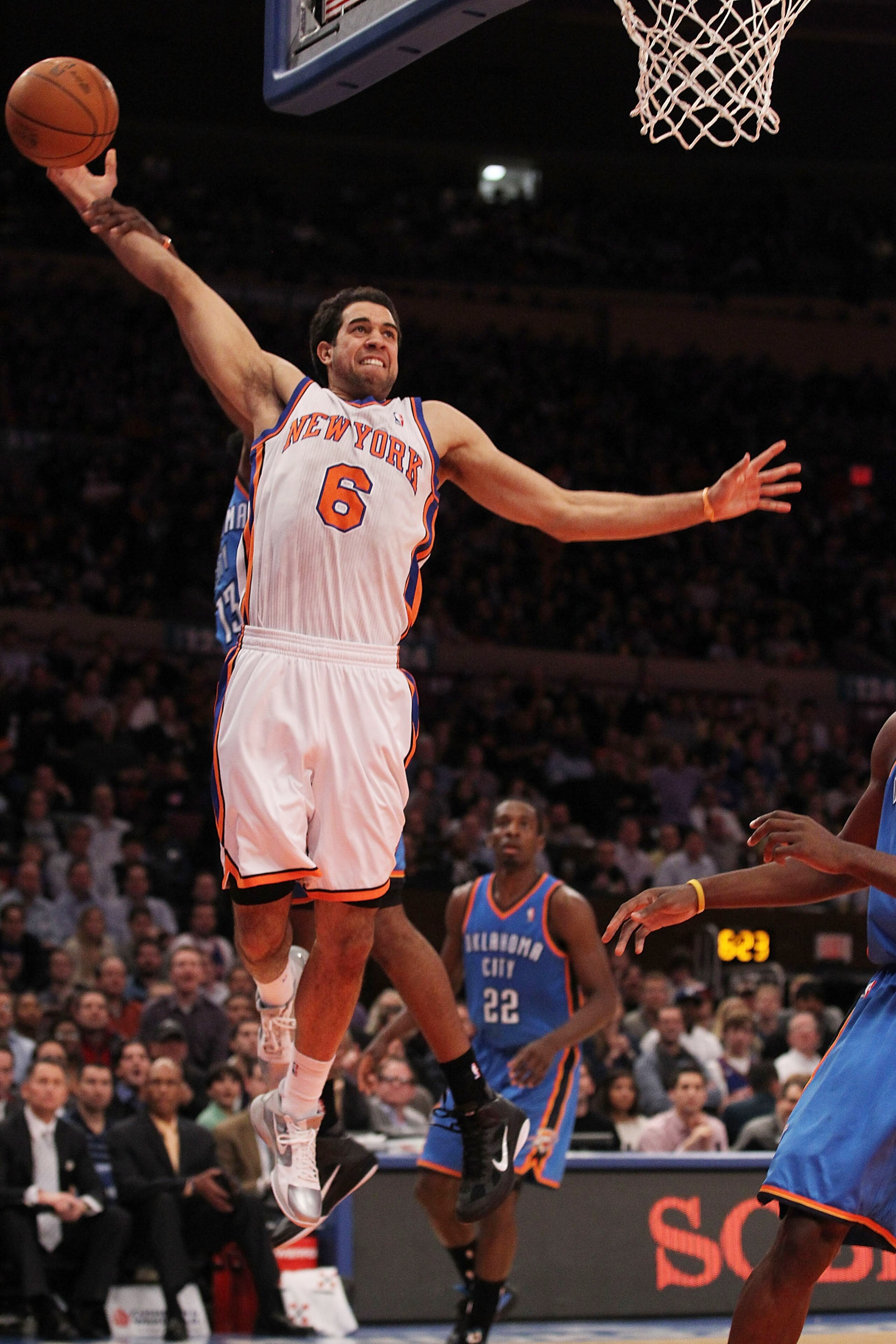 NEW YORK, NY - DECEMBER 22:  Landry Fields #6 of the New York Knicks is fouled by  the Oklahoma City Thunder at Madison Square Garden on December 22, 2010 in New York City.   NOTE TO USER: User expressly acknowledges and agrees that, by downloading and/or