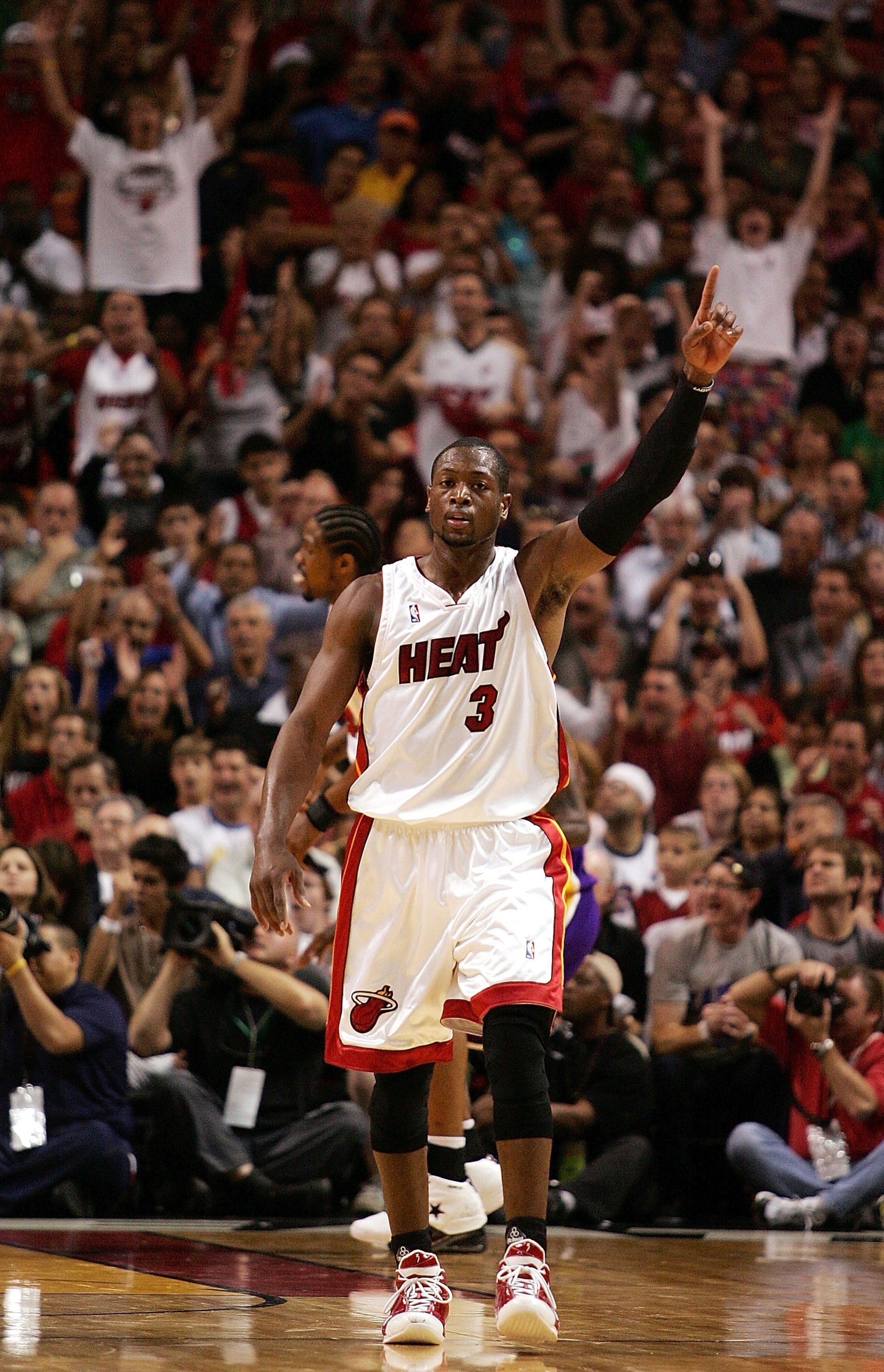 MIAMI - DECEMBER 25:  Guard Dwyane Wade #3 of the Miami Heat celebrates against the Los Angeles Lakers on December 25, 2006 at the American Airlines Arena in Miami, Florida.  NOTE TO USER: User expressly acknowledges and agrees that, by downloading and/or