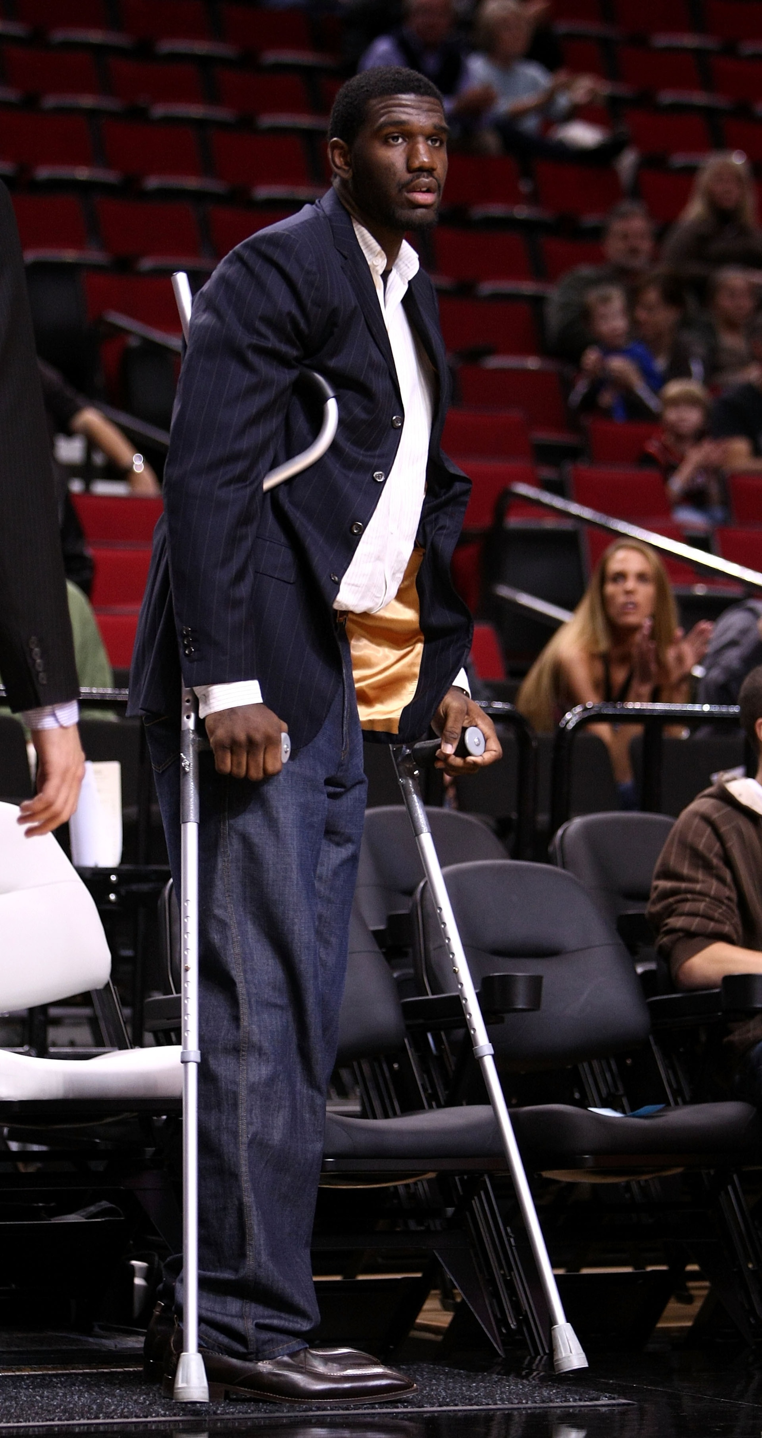 PORTLAND, OR - OCTOBER 10:  Greg Oden #52 of the Portland Trail Blazers, who is out for the season after under going micro fracture surgery in his knee, sits on the bench to watch a pre-season game against the Los Angeles Clippers at the Rose Garden on Oc