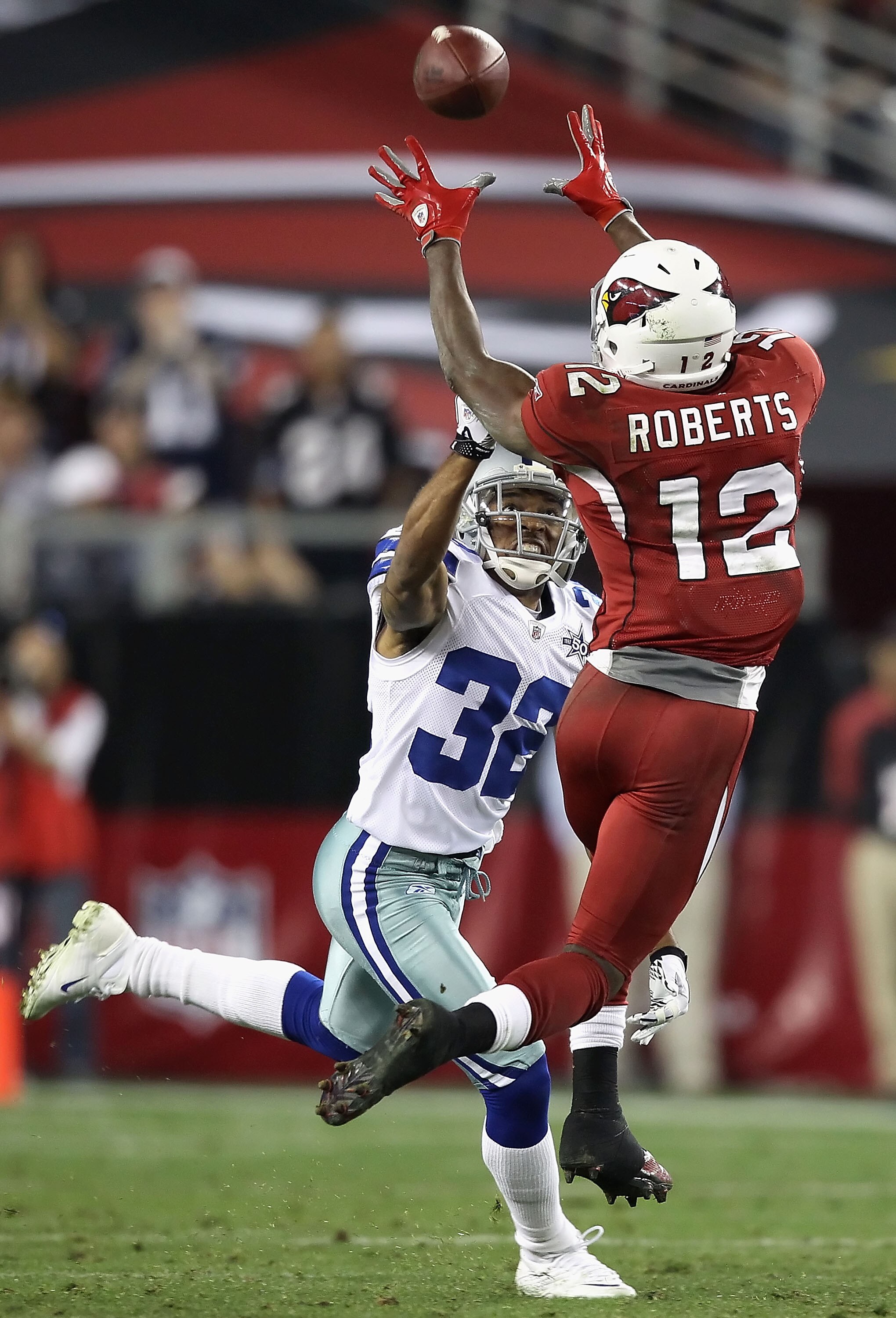 GLENDALE, AZ - DECEMBER 25:  Wide receiver Andre Roberts #12 of the Arizona Cardinals makes a leaping reception over Orlando Scandrick #32 of the Dallas Cowboys during the NFL game at the University of Phoenix Stadium on December 25, 2010 in Glendale, Ari